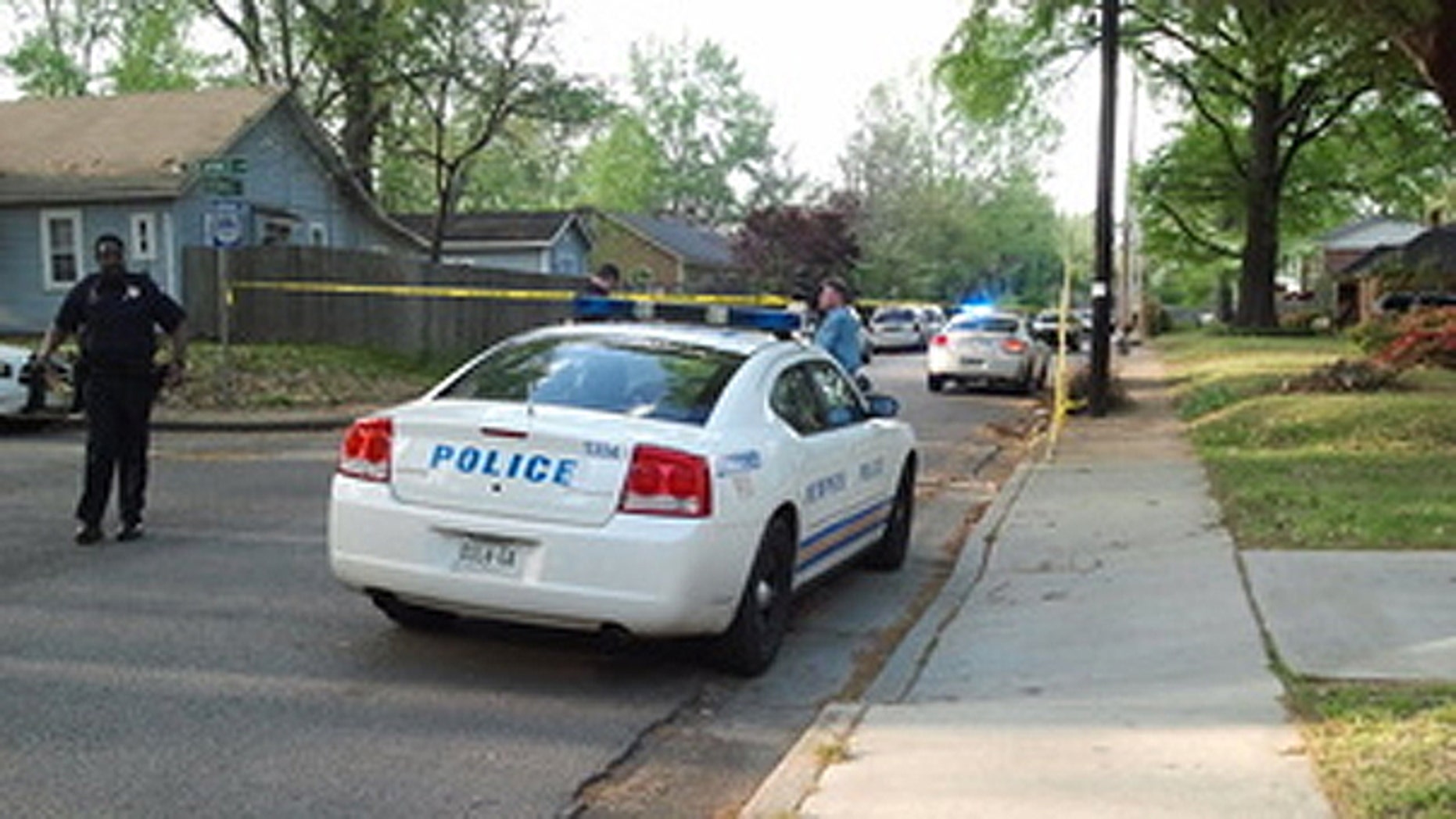 April 10: A policeman stands outside the home where three people were killed in a suspected murder-suicide.
