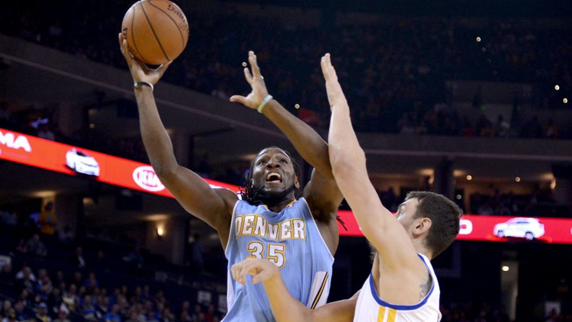 April 10, 2014; Oakland, CA, USA; Denver Nuggets forward Kenneth Faried (35) shoots the ball against Golden State Warriors center Andrew Bogut (12) during the first quarter at Oracle Arena. Mandatory Credit: Kyle Terada-USA TODAY Sports