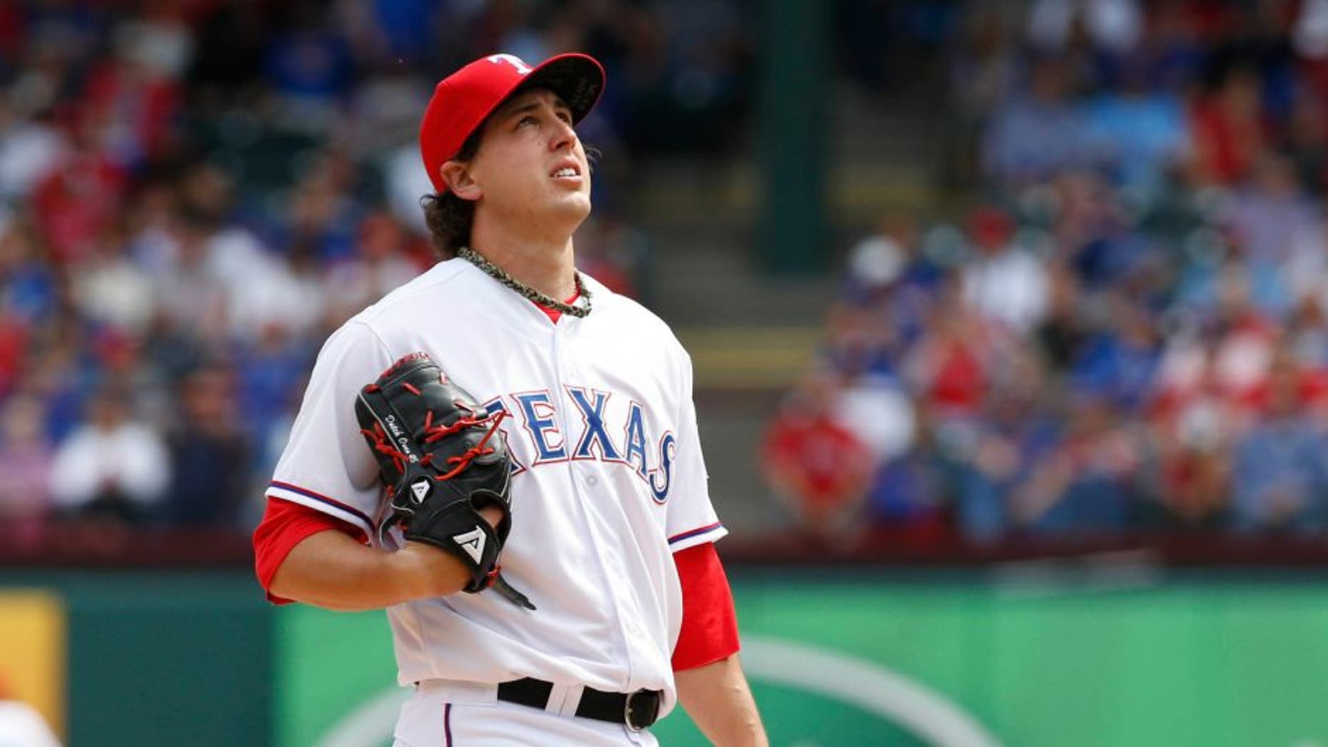 Apr 10, 2015; Arlington, TX, USA; Texas Rangers starting pitcher Derek Holland (45) prepares to pitch in the game against the Houston Astros at Globe Life Park in Arlington. Mandatory Credit: Tim Heitman-USA TODAY Sports