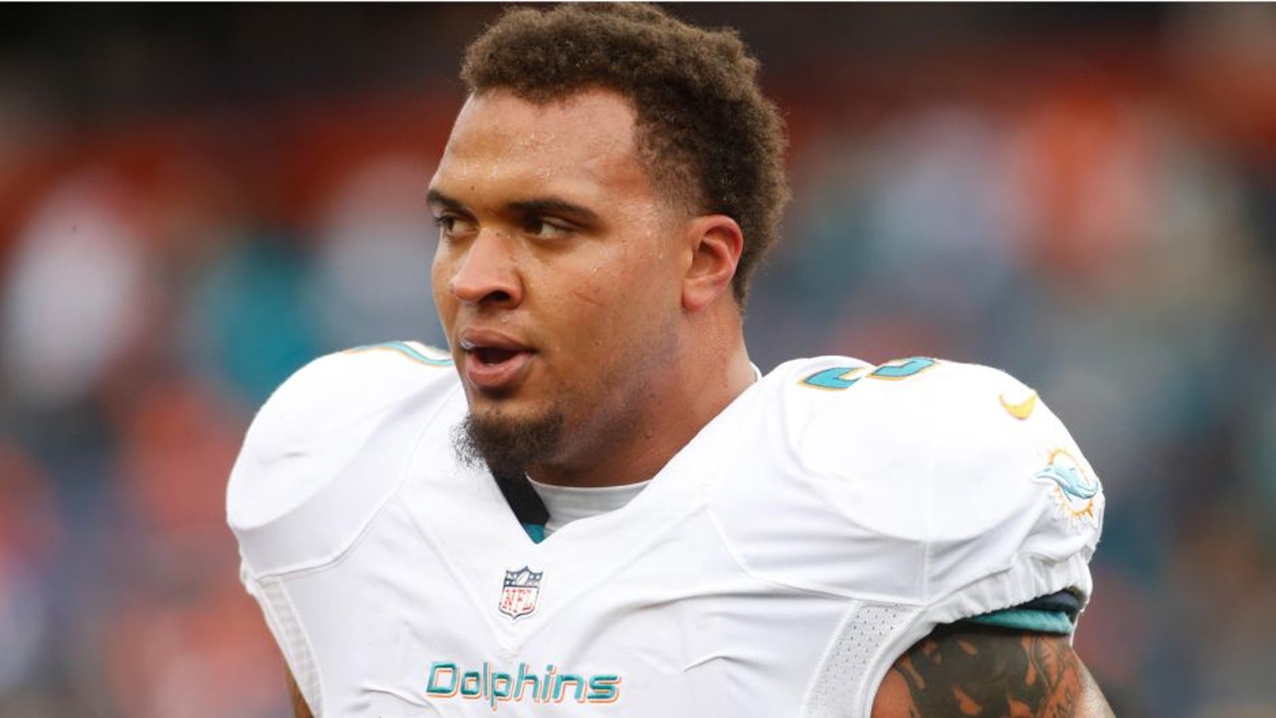 Nov 23, 2014; Denver, CO, USA; Miami Dolphins guard Mike Pouncey (51) before the game against the Denver Broncos at Sports Authority Field at Mile High. Mandatory Credit: Chris Humphreys-USA TODAY Sports