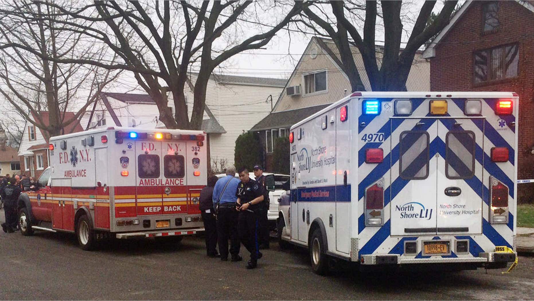 April 10, 2015: Emergency personel gather near a home where police say four people were found dead in an apparent carbon monoxide poisoning in the Queens borough of New York.
