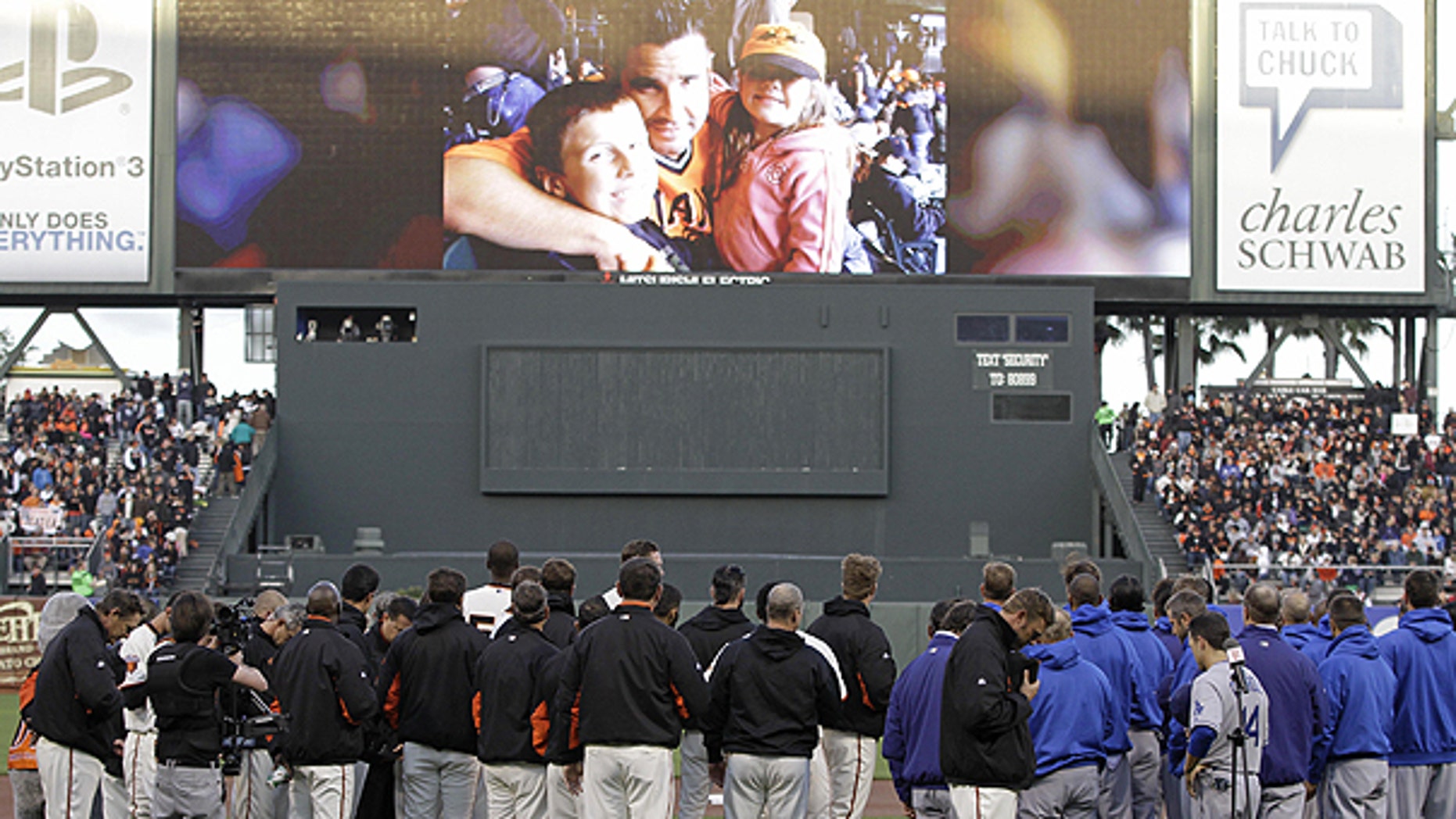 April 11: The San Francisco Giants and Los Angeles Dodgers stand for a moment of silence for paramedic Bryan Stow, pictured above, who was beaten at Dodger Stadium earlier this month, before their baseball game in San Francisco.