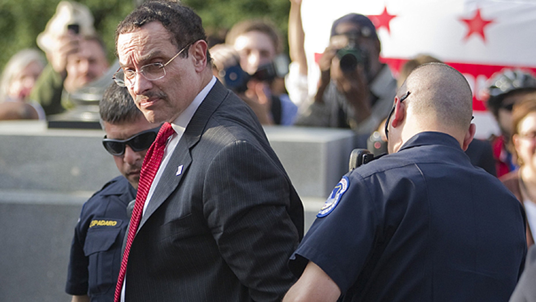 April 11: Mayor Vincent Gray is searched by Capitol Hill police after being arrested in Washington.