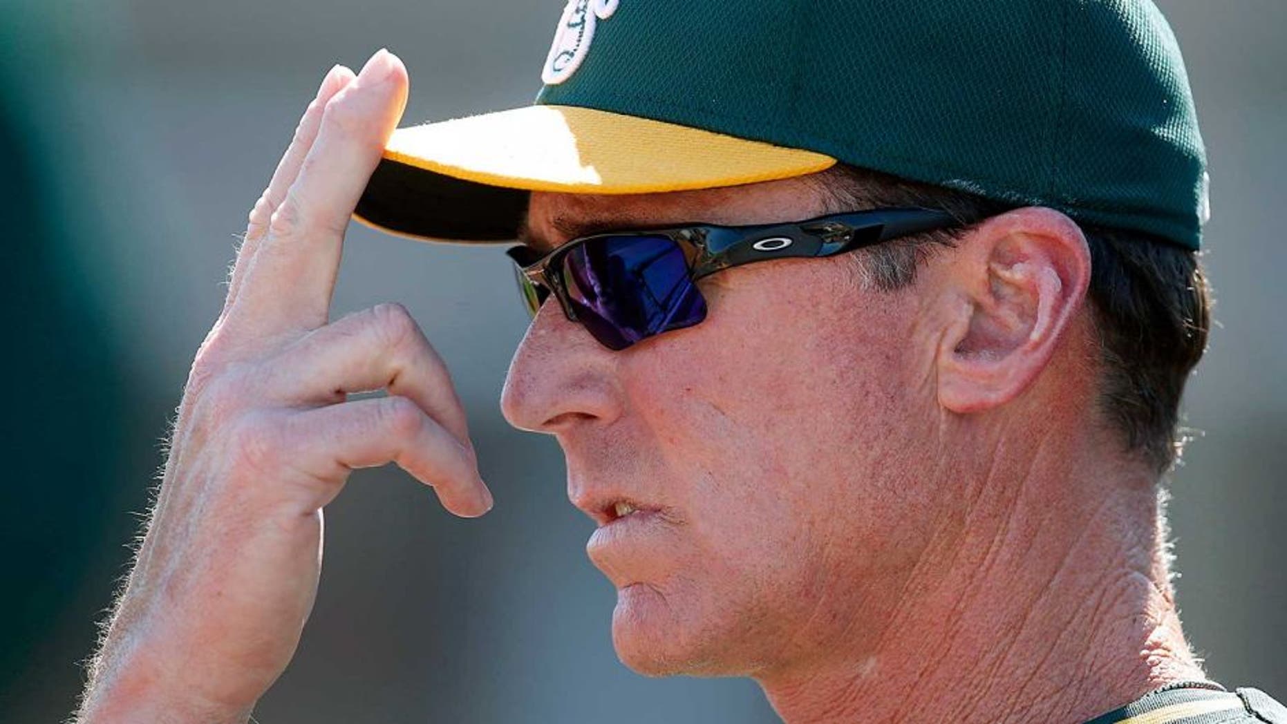 Mar 23, 2015; Goodyear, AZ, USA; Oakland Athletics manager Bob Melvin (6) gives out signs in the first inning against the Cleveland Indians during a spring training game at Goodyear Ballpark. Mandatory Credit: Rick Scuteri-USA TODAY Sports