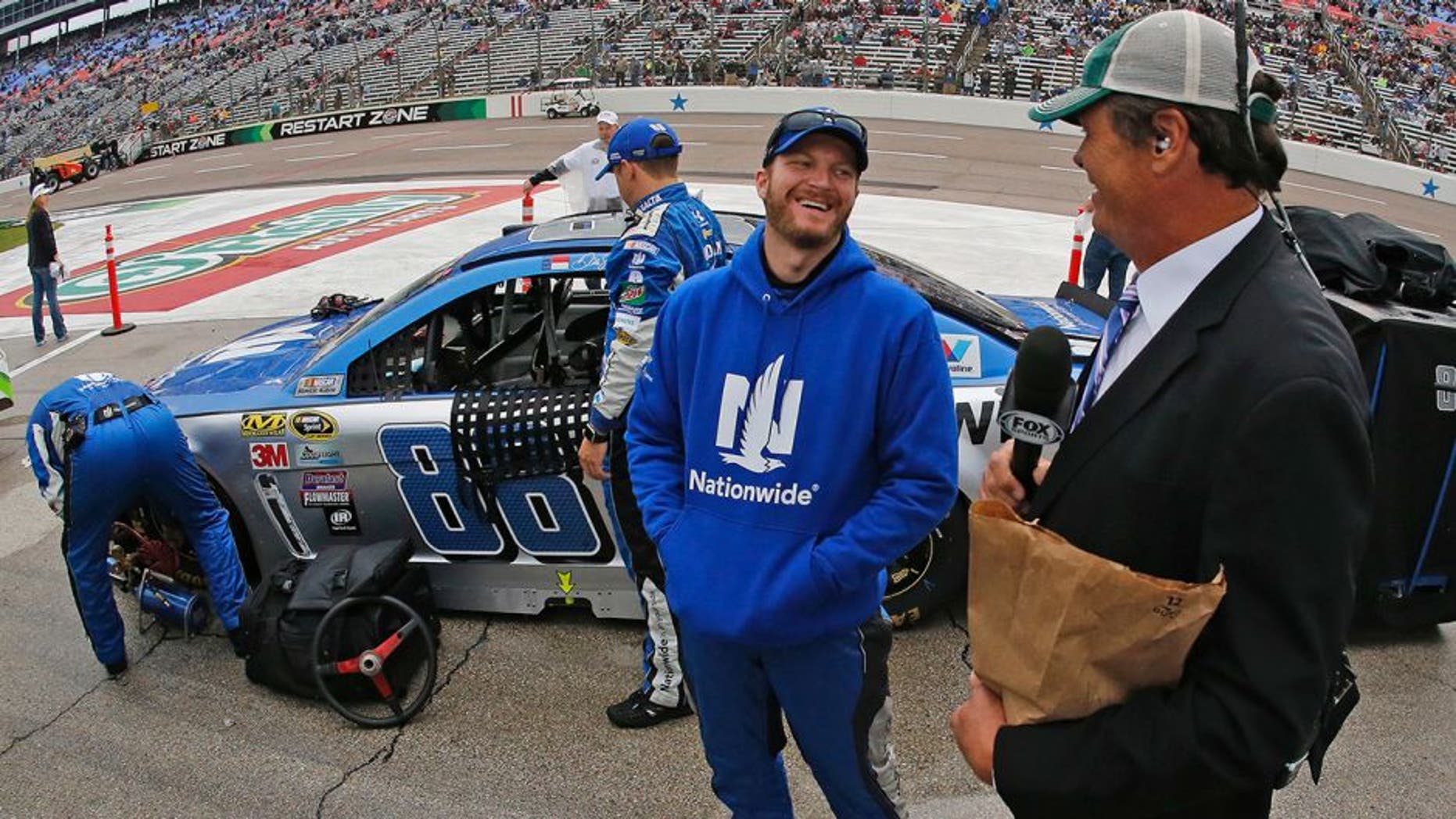 Sprint Cup Series driver Dale Earnhardt Jr. (88) with broadcaster Michael Waltrip on a rain-soaked pit row before the Duck Commander 500 on Saturday, April 9, 2016, at Texas Motor Speedway in Fort Worth, Texas. (Paul Moseley/Fort Worth Star-Telegram/TNS via Getty Images)