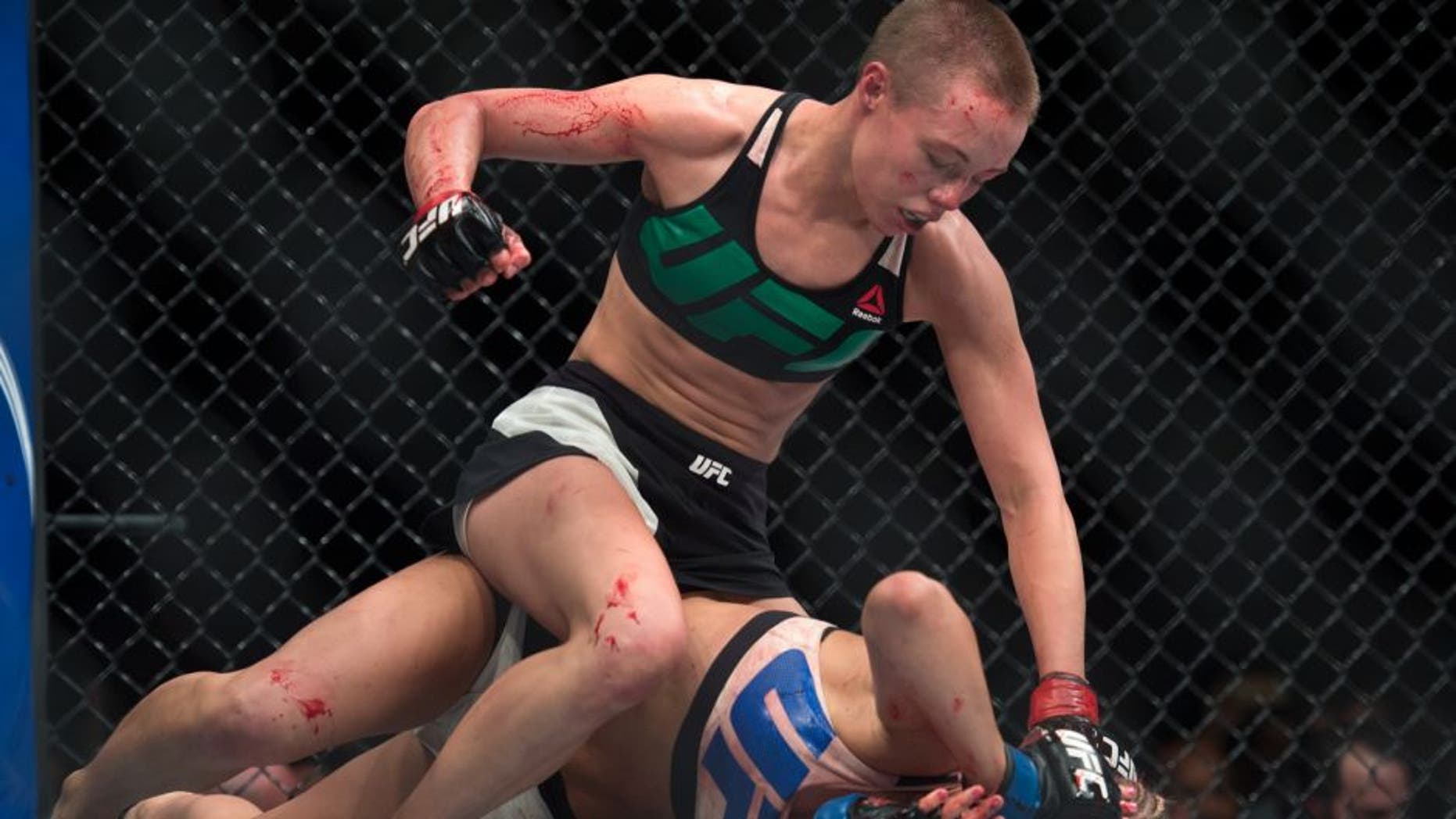 LAS VEGAS, NEVADA - DECEMBER 10: (Top) Rose Namajunas punches Paige VanZant in their women's strawweight bout during the UFC Fight Night event at The Chelsea at the Cosmopolitan of Las Vegas on December 10, 2015 in Las Vegas, Nevada. (Photo by Brandon Magnus/Zuffa LLC/Zuffa LLC via Getty Images)