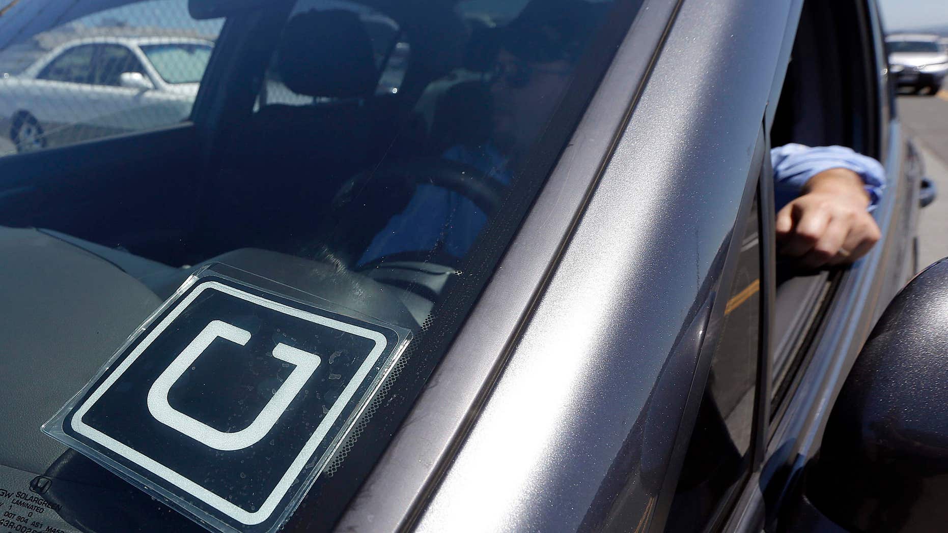 July 15, 2015: Uber driver Karim Amrani sits in his car parked near the San Francisco International Airport parking area.