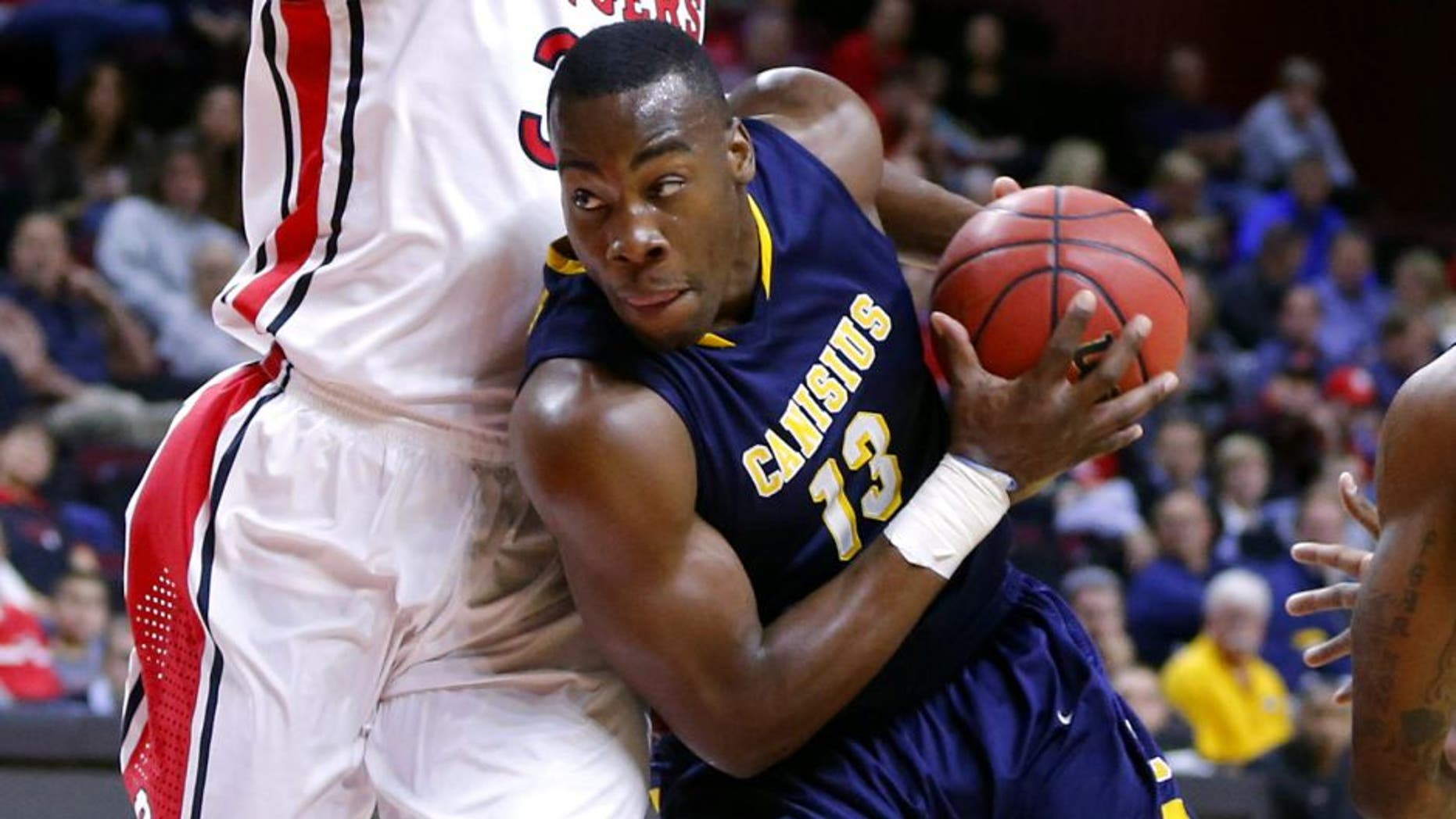 Nov 18, 2013; Piscataway, NJ, USA; Canisius Golden Griffins forward Chris Manhertz (13) drives to the basket during the first half against Rutgers Scarlet Knights forward Wally Judge (33) at the Louis Brown Athletic Center. Mandatory Credit: Jim O'Connor-USA TODAY Sports