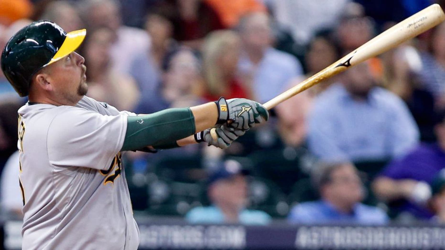 Apr 13, 2015; Houston, TX, USA; Oakland Athletics designated hitter Billy Butler (16) hits a home run during the fifth inning against the Houston Astros at Minute Maid Park. Mandatory Credit: Troy Taormina-USA TODAY Sports