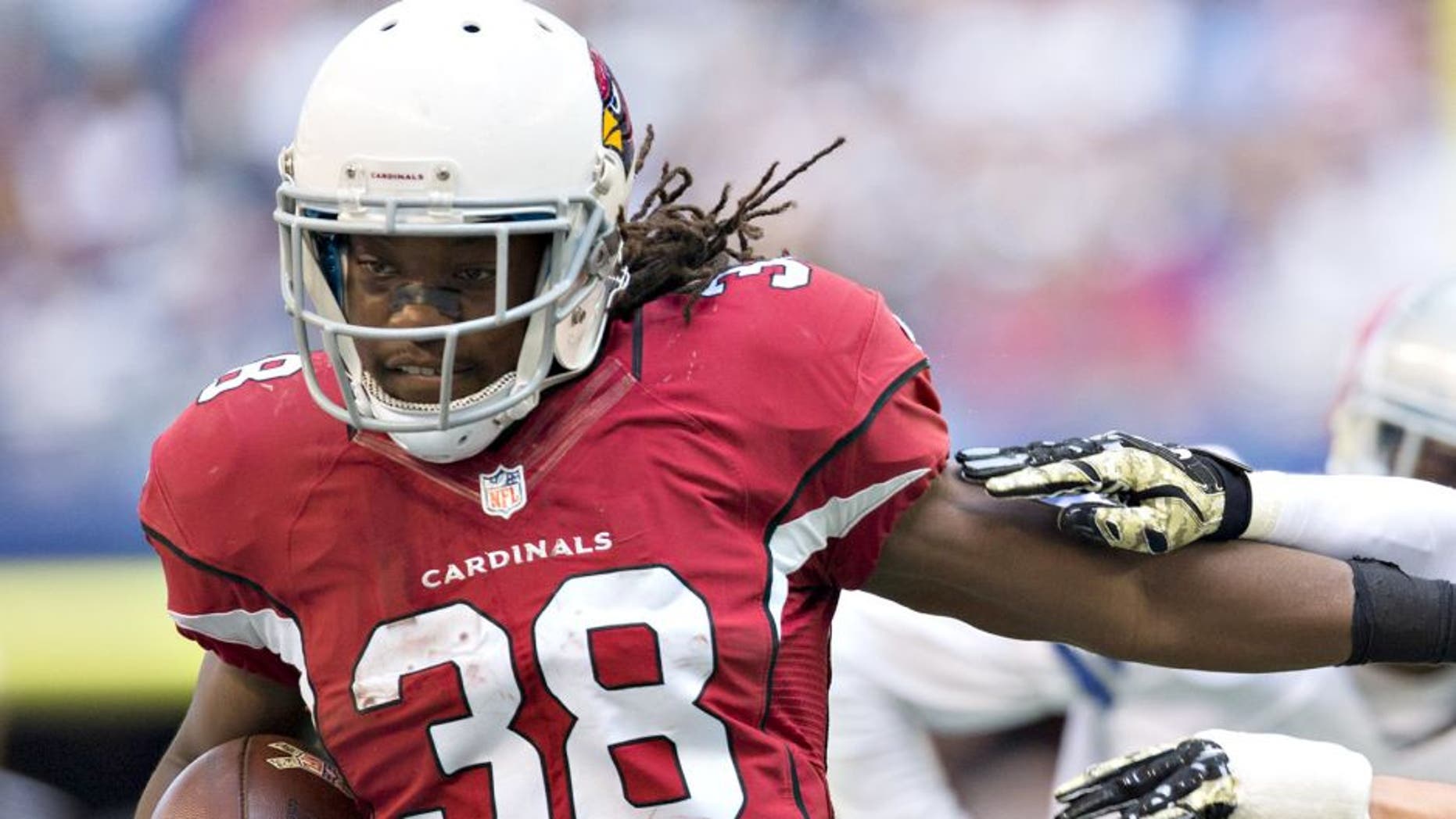 ARLINGTON, TX - NOVEMBER 02: Andre Ellington #38 of the Arizona Cardinals stiff arms Jeff Heath #38 of the Dallas Cowboys at AT&T Stadium on November 2, 2014 in Arlington, Texas. The Cardinals defeated the Cowboys 28-17. (Photo by Wesley Hitt/Getty Images)