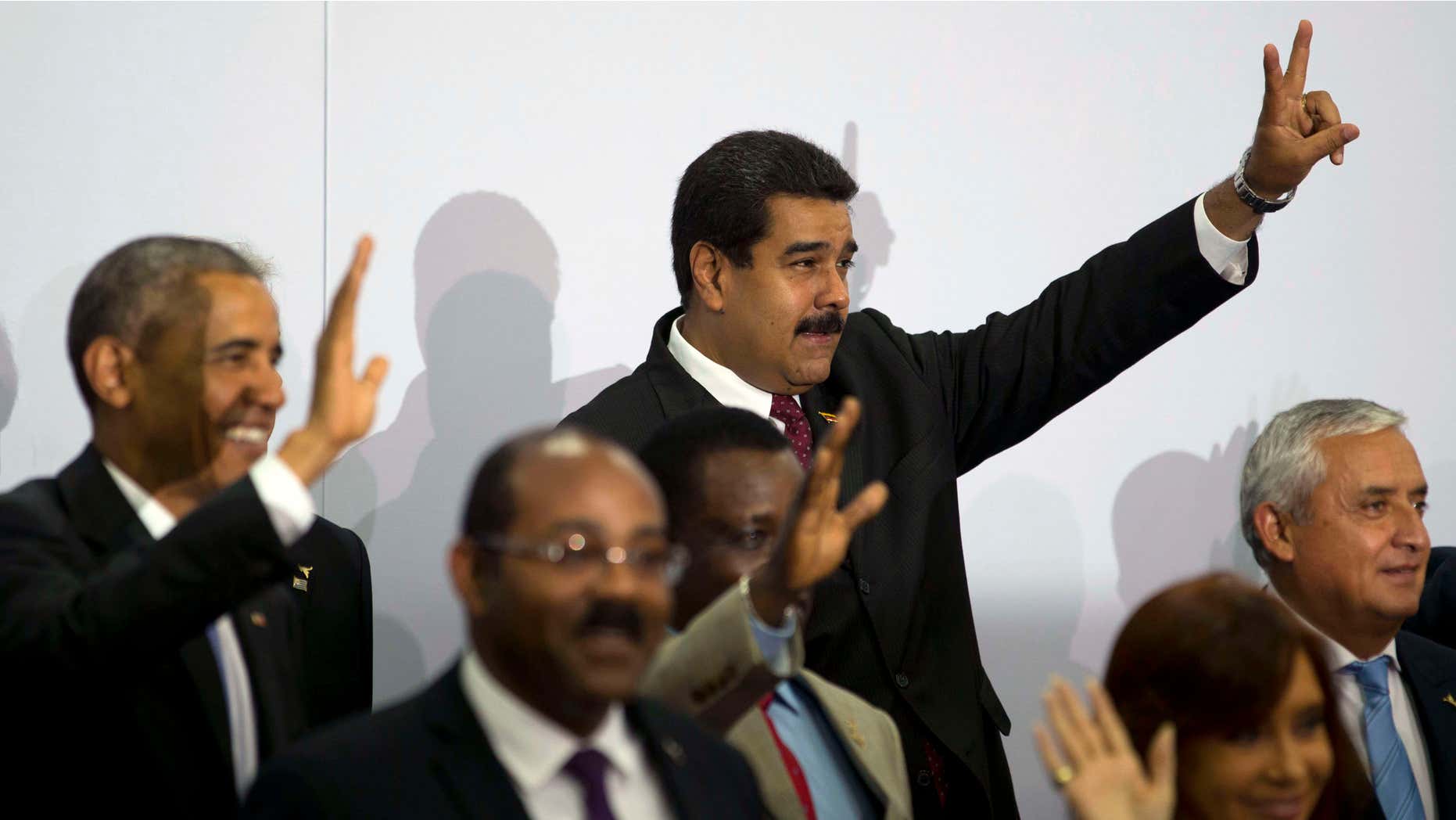 April 11, 2015: Venezuela's President Nicolas Maduro, center top, flashes a sign during the VII Summit of the Americas' official group photo in Panama City, Panama.