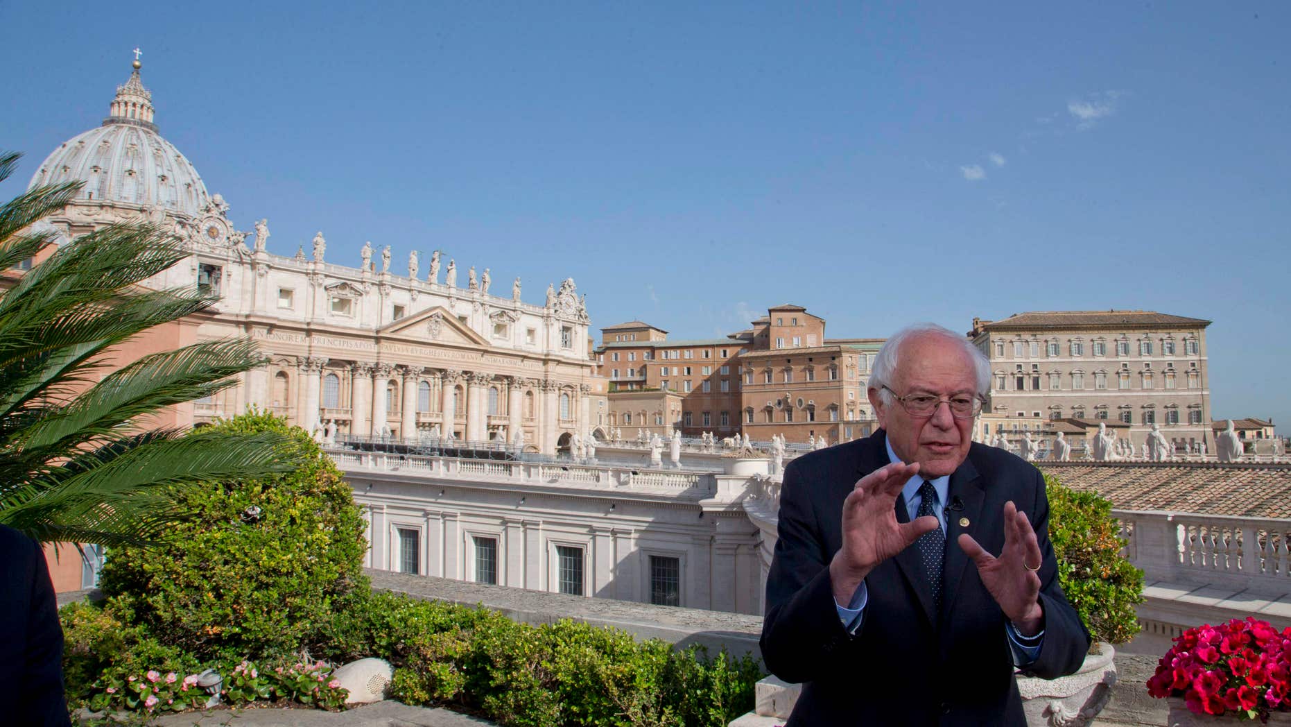 April 16, 2016: US presidential candidate Bernie Sanders, backdropped by St. Peter's Basilica, talks during an interview with the Associated Press, at the Vatican.