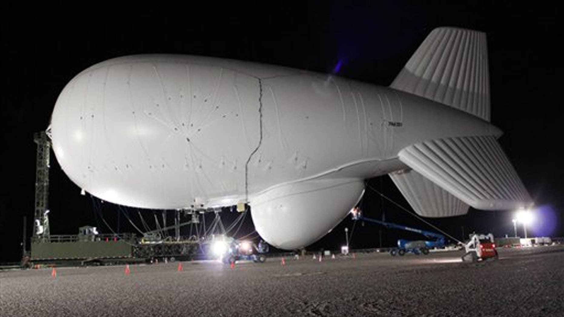 A 242-foot-long dirigible being inflated in Utah at the U.S. Air Force's Utah Test and Training Range about 80 miles west of Salt Lake City, Utah. The military is planning a series of tests of the helium-filled airships in Utah in the coming years. The work is an effort to prove the abilities of unmanned radar-bearing dirigibles, known as aerostats, to give field commanders a bird's eye view of cruise missiles and other nearby threats.