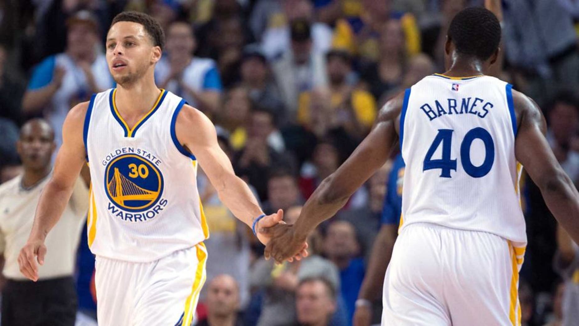 April 9, 2015; Oakland, CA, USA; Golden State Warriors guard Stephen Curry (30) celebrates with forward Harrison Barnes (40) against the Portland Trail Blazers during the first quarter at Oracle Arena. Mandatory Credit: Kyle Terada-USA TODAY Sports