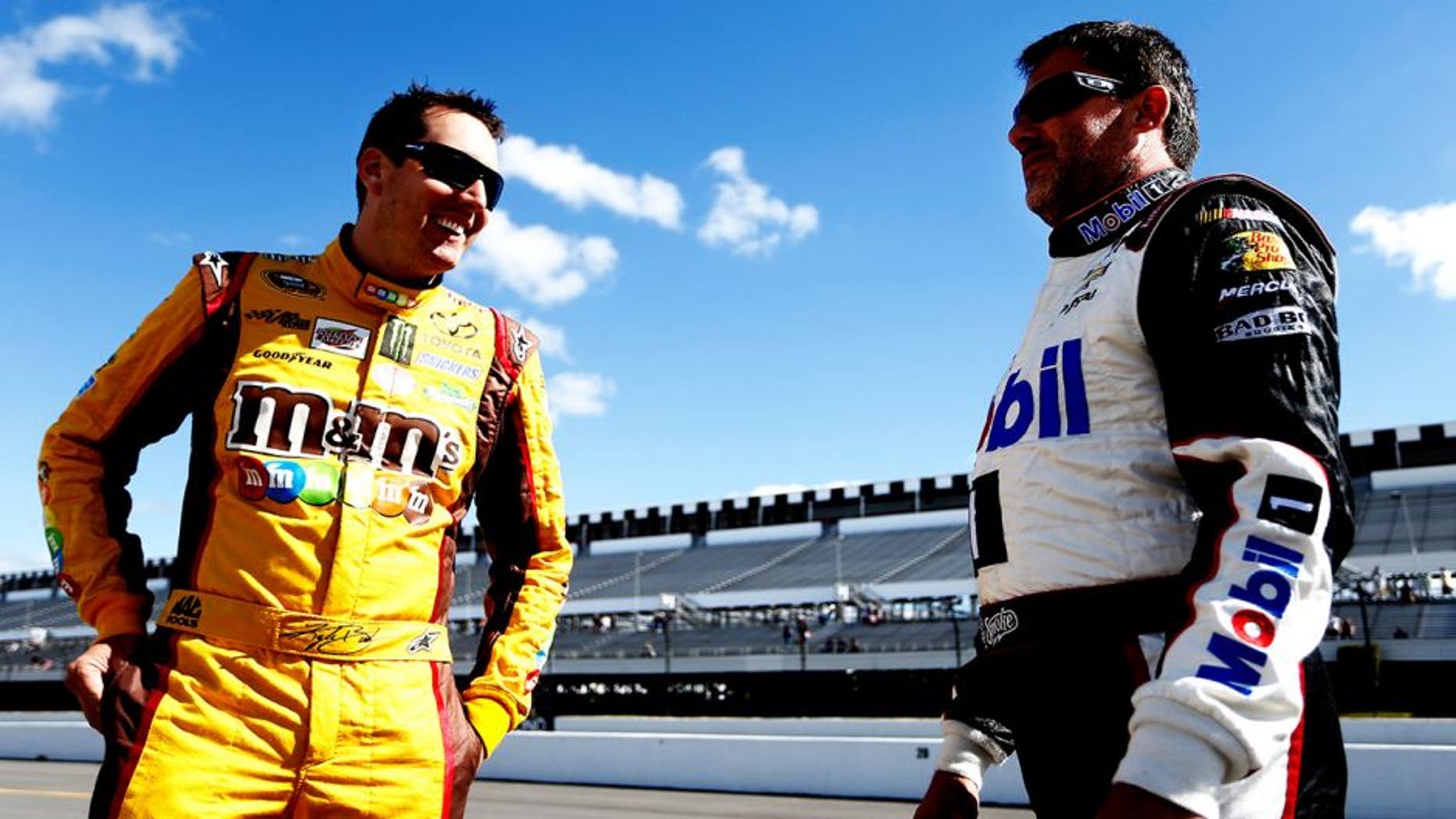 LONG POND, PA - JUNE 06: Kyle Busch, driver of the #18 M&M's Peanut Butter Toyota, left, talks with Tony Stewart, driver of the #14 Mobil 1/Bass Pro Shops Chevrolet, on the grid during qualifying for the NASCAR Sprint Cup Series Pocono 400 at Pocono Raceway on June 6, 2014 in Long Pond, Pennsylvania. (Photo by Jeff Zelevansky/Getty Images)