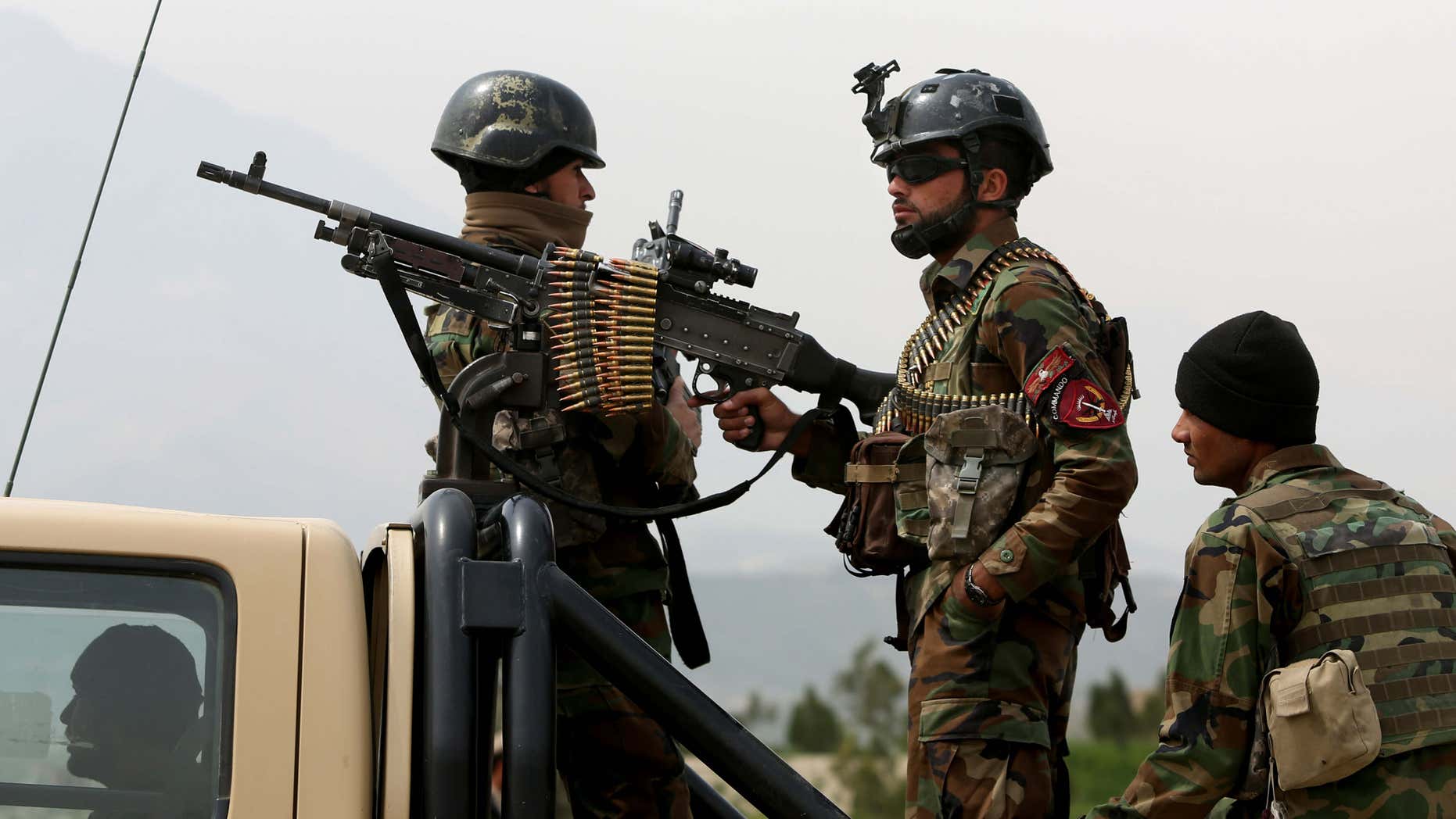 March 28, 2016: Afghan military soldiers stand stand alert at the entrance gate of the new parliament building after a rocket attack in Kabul, Afghanistan.