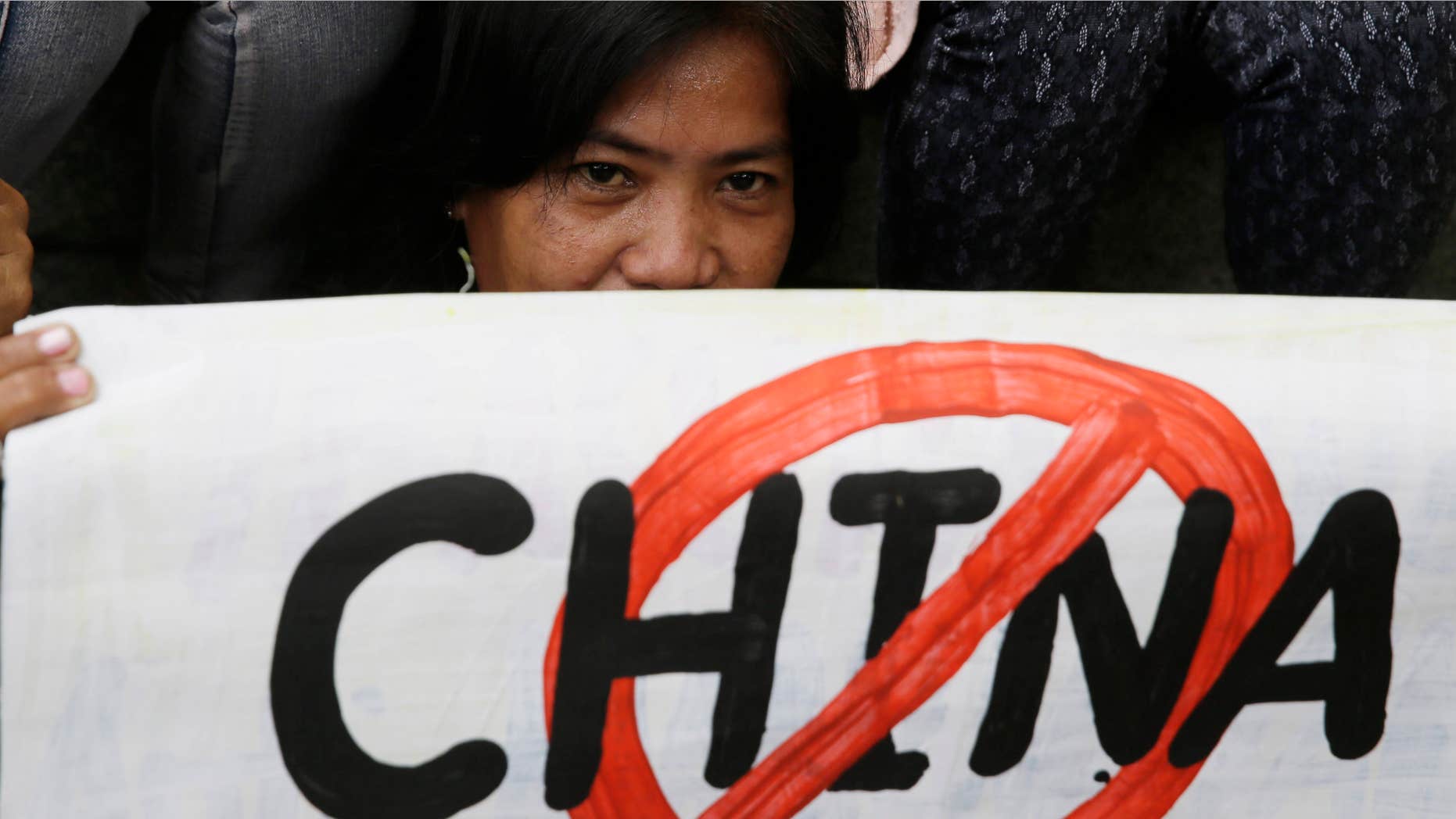 April 17, 2015: A protester displays a placard during a rally at the Chinese Consulate at the financial district of Makati city, east of Manila, Philippines.