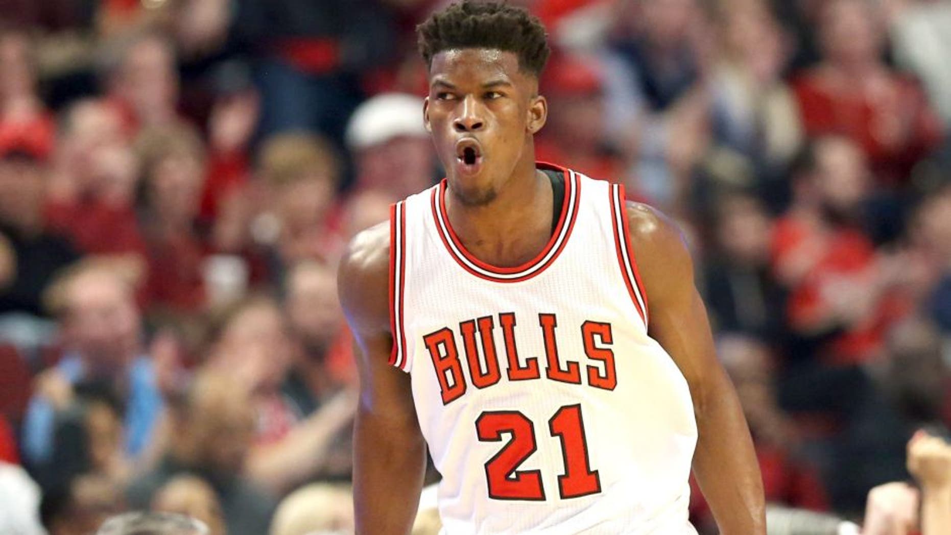 Apr 18, 2015; Chicago, IL, USA; Chicago Bulls guard Jimmy Butler (21) reacts after making a three-point basket against the Milwaukee Bucks during the first quarter in game one of the first round of the 2015 NBA Playoffs at United Center. Mandatory Credit: Jerry Lai-USA TODAY Sports