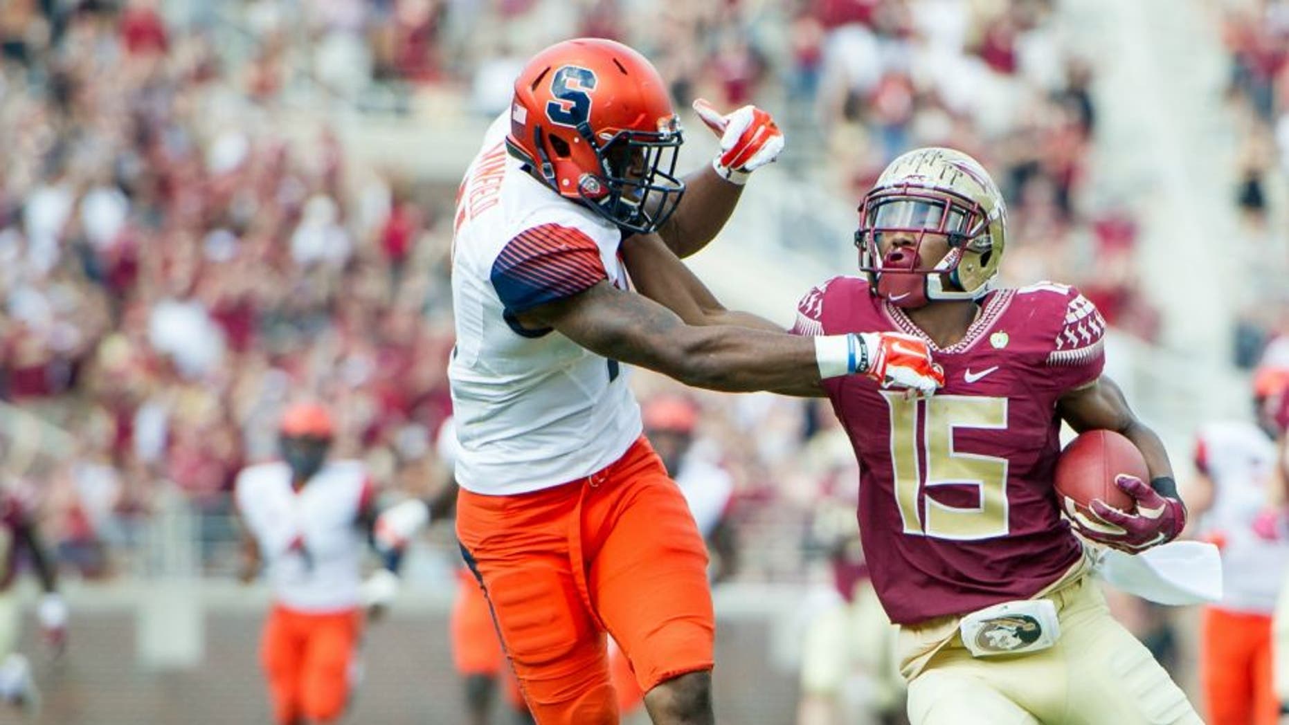 TALLAHASSEE, FL - OCTOBER 31: Wide receiver Travis Rudolph #15 of the Florida State Seminoles pushes cornerback Corey Winfield #11 of the Syracuse Orange while running the ball downfield on October 31, 2015 at Doak Campbell Stadium in Tallahassee, FL. (Photo by Michael Chang/Getty Images)