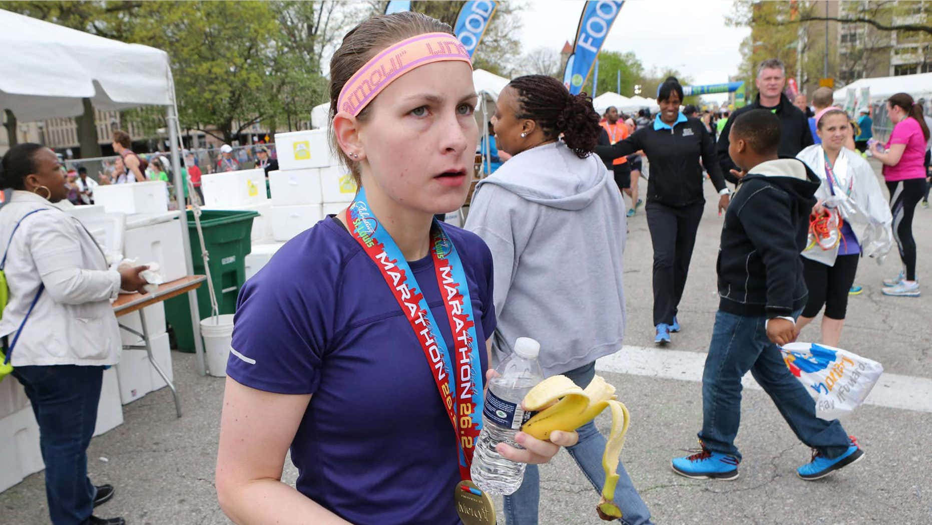 April 12, 2015: Kendall Schler, 26, is seen moments after crossing the finish line of the Go! Marathon.