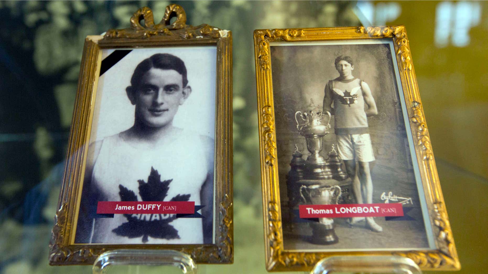June 14, 2014: In this photo illustrations of World War I soldiers and Boston Marathon winners James Duffy, 1914, and Tom Longboat, 1907, are framed behind glass on exhibit at the In Flanders Fields Museum in Ypres, Belgium.