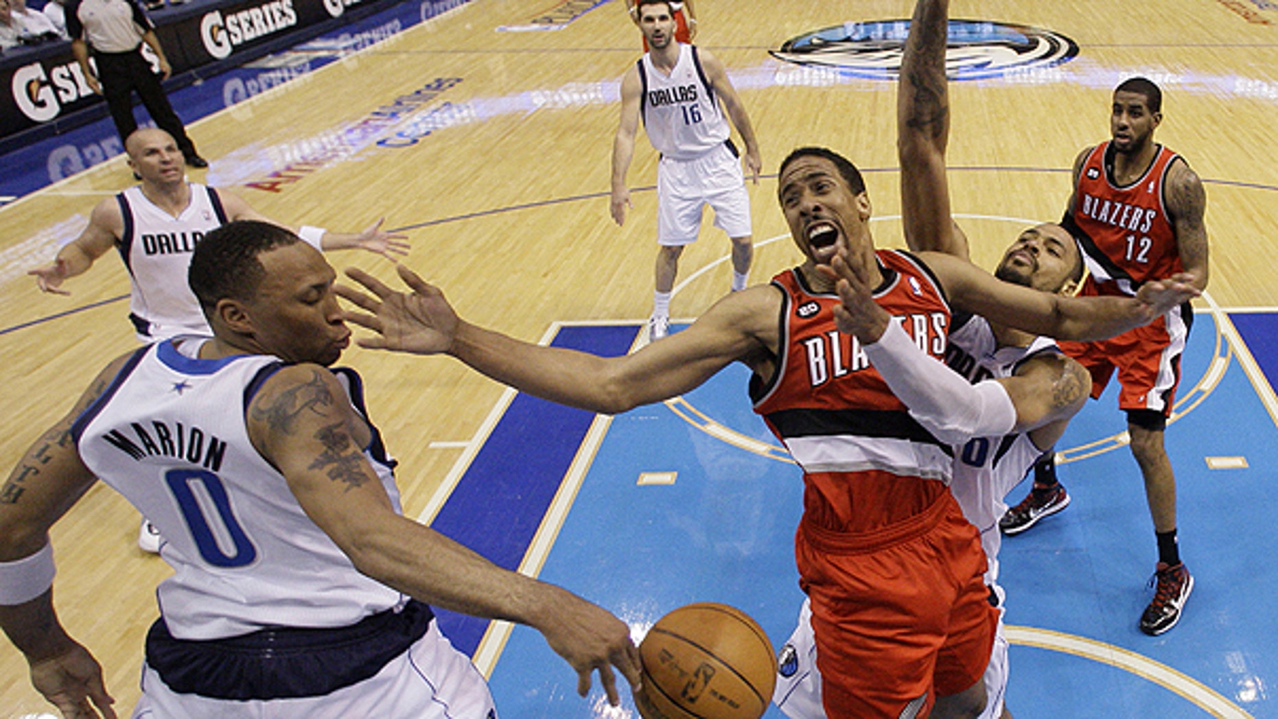 April 19: Portland Trail Blazers' Andre Miller, center, loses control of the ball going to the basket against Dallas Mavericks' Shawn Marion (0) and Tyson Chandler, right, in the second half of an NBA basketball game in Dallas.