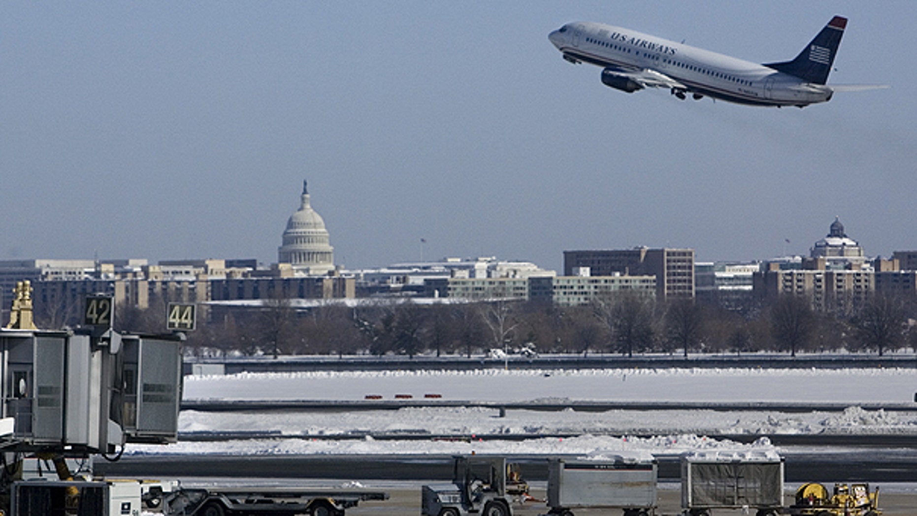 In this Feb. 8, 2010 file photo, with the U.S. Capitol in the background, a US Airways plane takes off from Washington's Reagan National Airport.