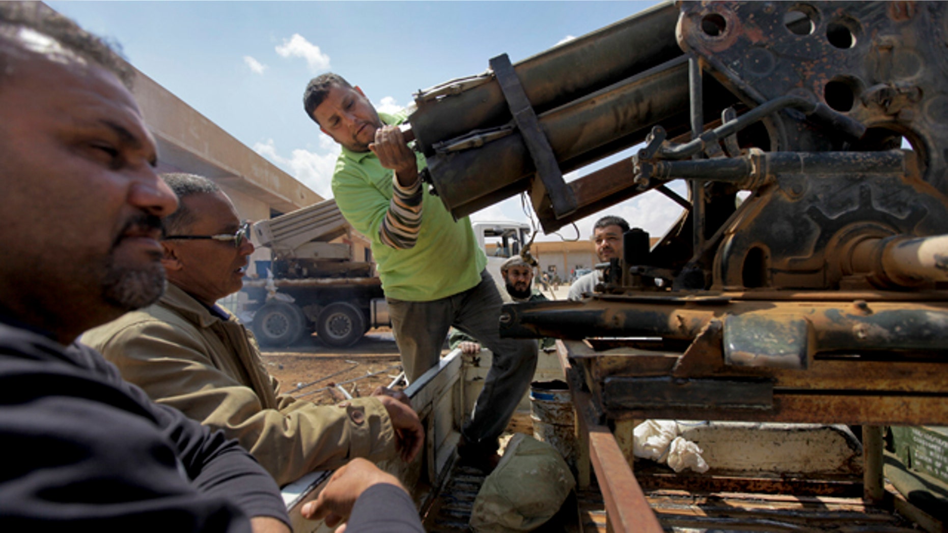 April 19: Workmen prepare a Grad rocket launcher for operation at a Libyan rebel weapons workshop and training camp in Benghazi, Libya.