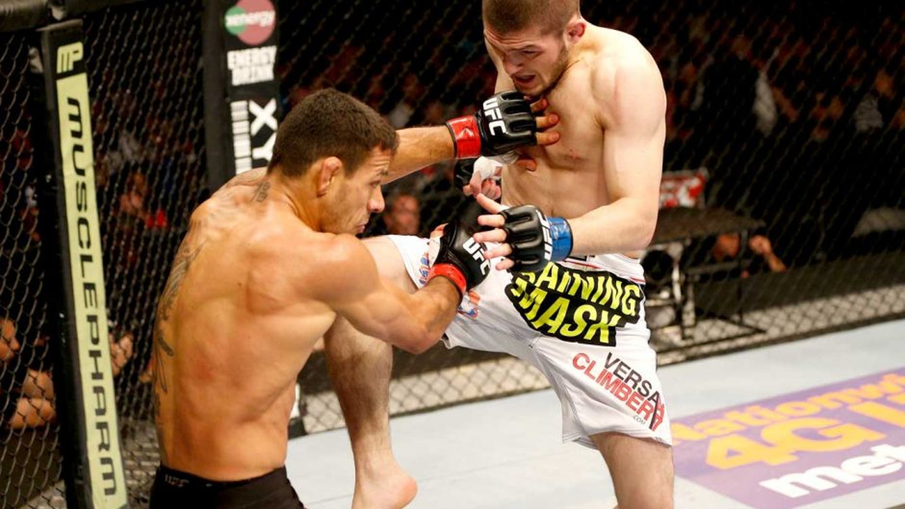 ORLANDO, FL - APRIL 19: (R-L) Khabib Nurmagomedov lands a flying knee against Rafael dos Anjos in their lightweight bout during the FOX UFC Saturday event at the Amway Center on April 19, 2014 in Orlando, Florida. (Photo by Josh Hedges/Zuffa LLC/Zuffa LLC via Getty Images)