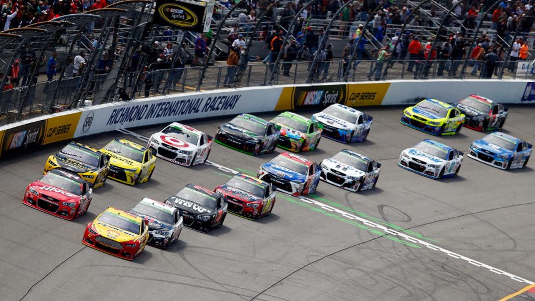 RICHMOND, VA - APRIL 26: Joey Logano, driver of the #22 Shell-Pennzoil Ford, and Kurt Busch, driver of the #41 Haas Automation Chevrolet, lead the field for a restart following a caution flag during the NASCAR Sprint Cup Series Toyota Owners 400 at Richmond International Raceway on April 26, 2015 in Richmond, Virginia. (Photo by Kevin C. Cox/Getty Images)