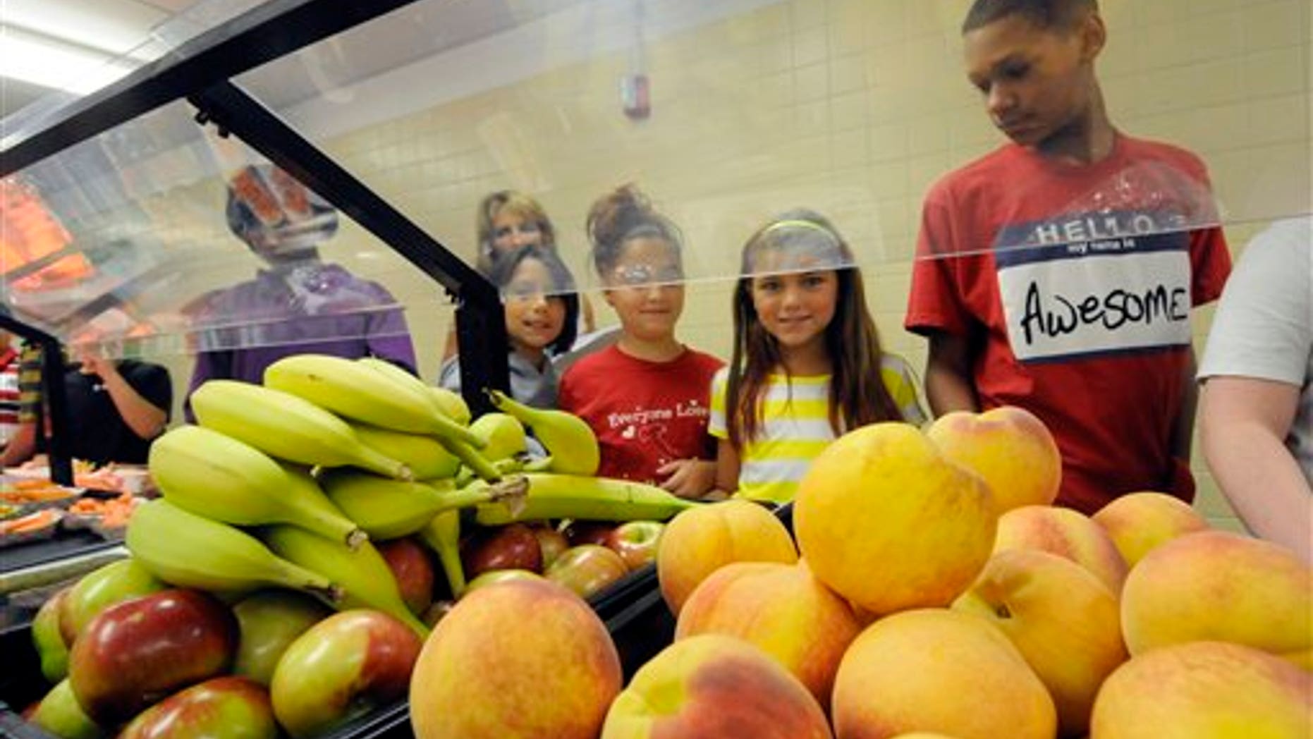 Students select food items from the lunch line of the cafeteria at Draper Middle School in Rotterdam, N.Y., Tuesday, Sept. 11, 2012. The leaner, greener school lunches served under new federal standards are getting mixed grades from students. (AP Photo/Hans Pennink)