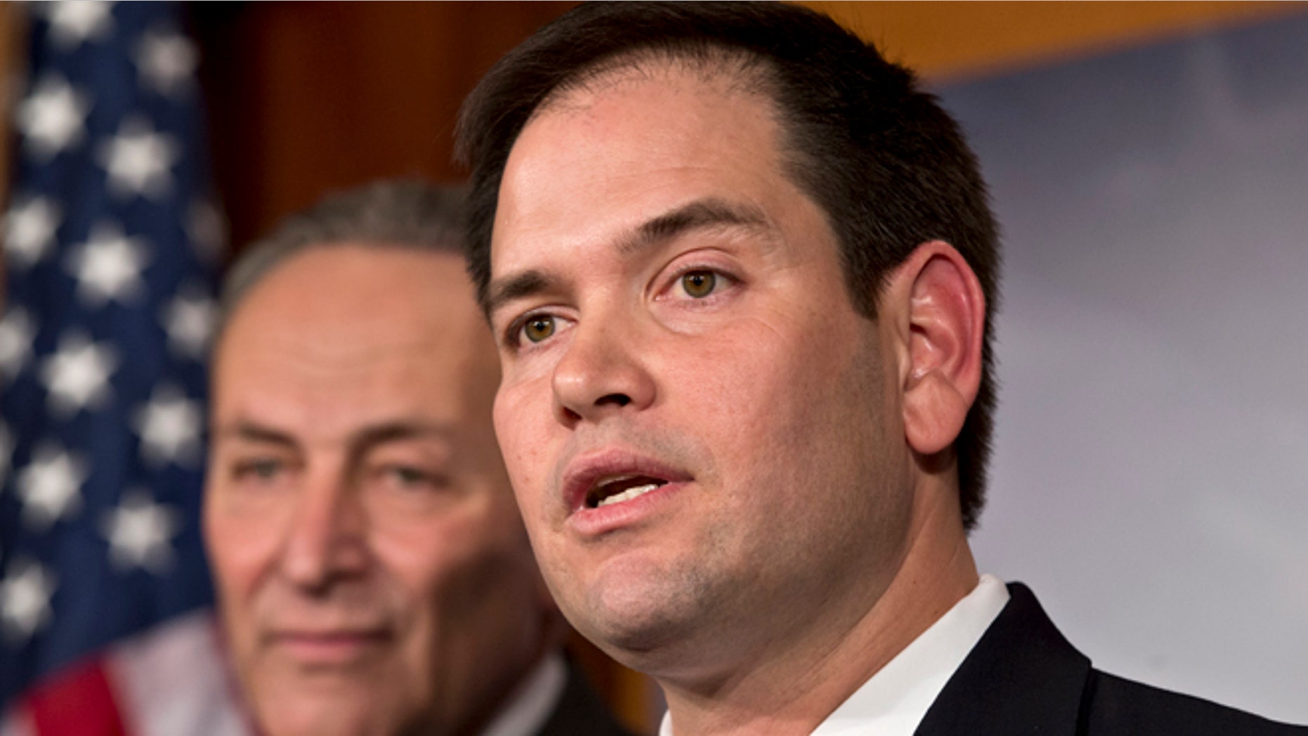 FILE - In this Jan. 28, 2013, photo, Sen. Marco Rubio, R-Fla., right, and Sen. Charles Schumer, D-N.Y., left, join a bipartisan group of leading senators to announce that they have reached agreement on the principles of sweeping legislation to rewrite the nation's immigration laws, during a news conference at the Capitol in Washington. Republicans face a delicate balancing act as they embrace immigration reform _ and no one is more symbolic of the potential risks and rewards than Rubio. (AP Photo/J. Scott Applewhite)