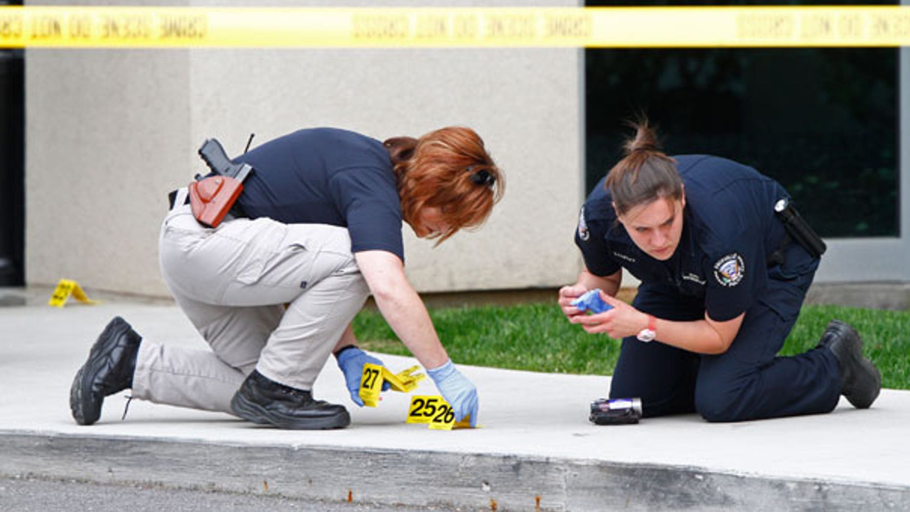 April 19: Police work the scene where a gunman opened fire outside Parkwest Medical Center in Knoxville, Tenn., killing a woman and injuring two others before committing suicide.