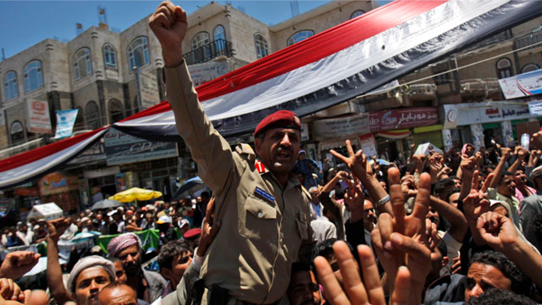 April 20: A Yemeni army officer lifted by anti-government protestors reacts during a demonstration demanding the resignation of Yemeni President Ali Abdullah Saleh in Sanaa, Yemen.