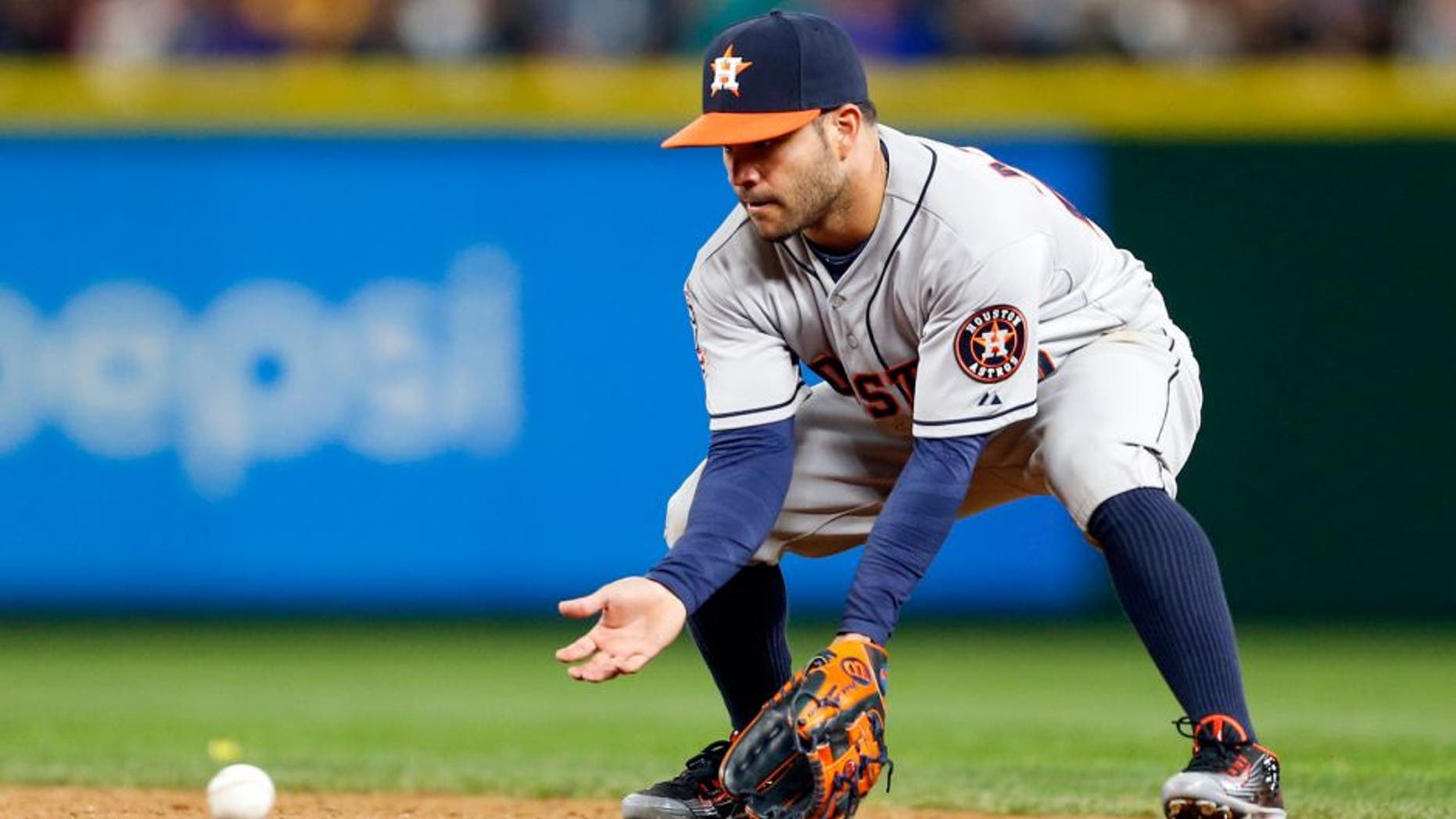 Apr 20, 2015; Seattle, WA, USA; Houston Astros second baseman Jose Altuve (27) fields a grounder against the Seattle Mariners during the eighth inning at Safeco Field. Houston defeated Seattle, 7-5. Mandatory Credit: Joe Nicholson-USA TODAY Sports