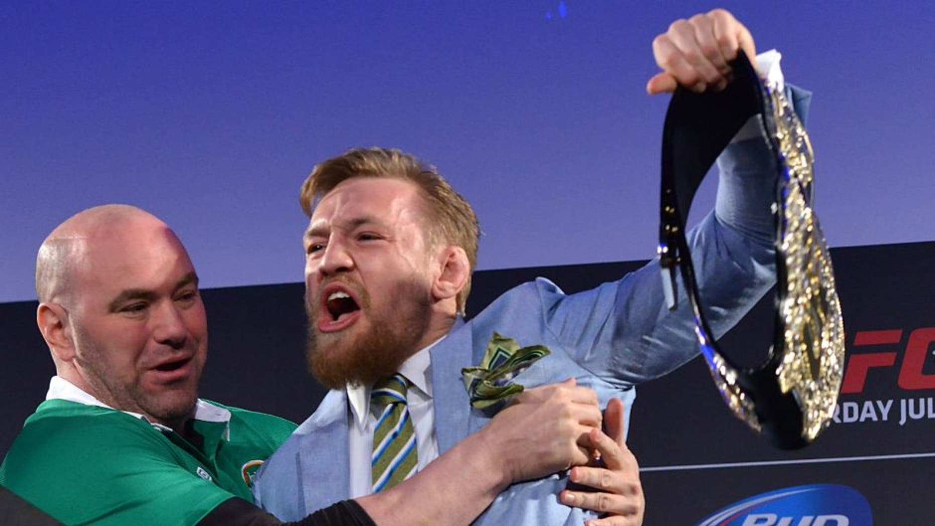 DUBLIN, IRELAND - MARCH 31: UFC featherweight title challenger Conor 'The Notorious' McGregor (R) steals UFC Featherweight Champion Jose Aldo's (L) belt as UFC President Dana White (C) separates the two during the UFC 189 World Championship Fan Event on March 31, 2015 in Dublin, Ireland. (Photo by Jeff Bottari/Zuffa LLC/Zuffa LLC via Getty Images)