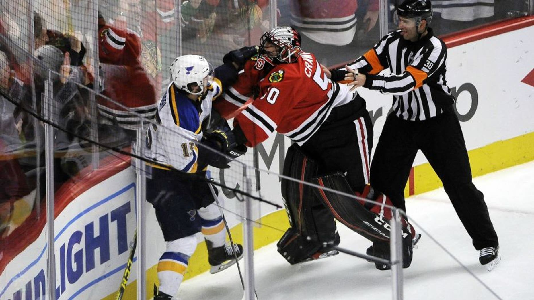 Apr 19, 2016; Chicago, IL, USA; St. Louis Blues center Robby Fabbri (15) and Chicago Blackhawks goalie Corey Crawford (50) fight during the second period in game four of the first round of the 2016 Stanley Cup Playoffs at United Center. Mandatory Credit: David Banks-USA TODAY Sports