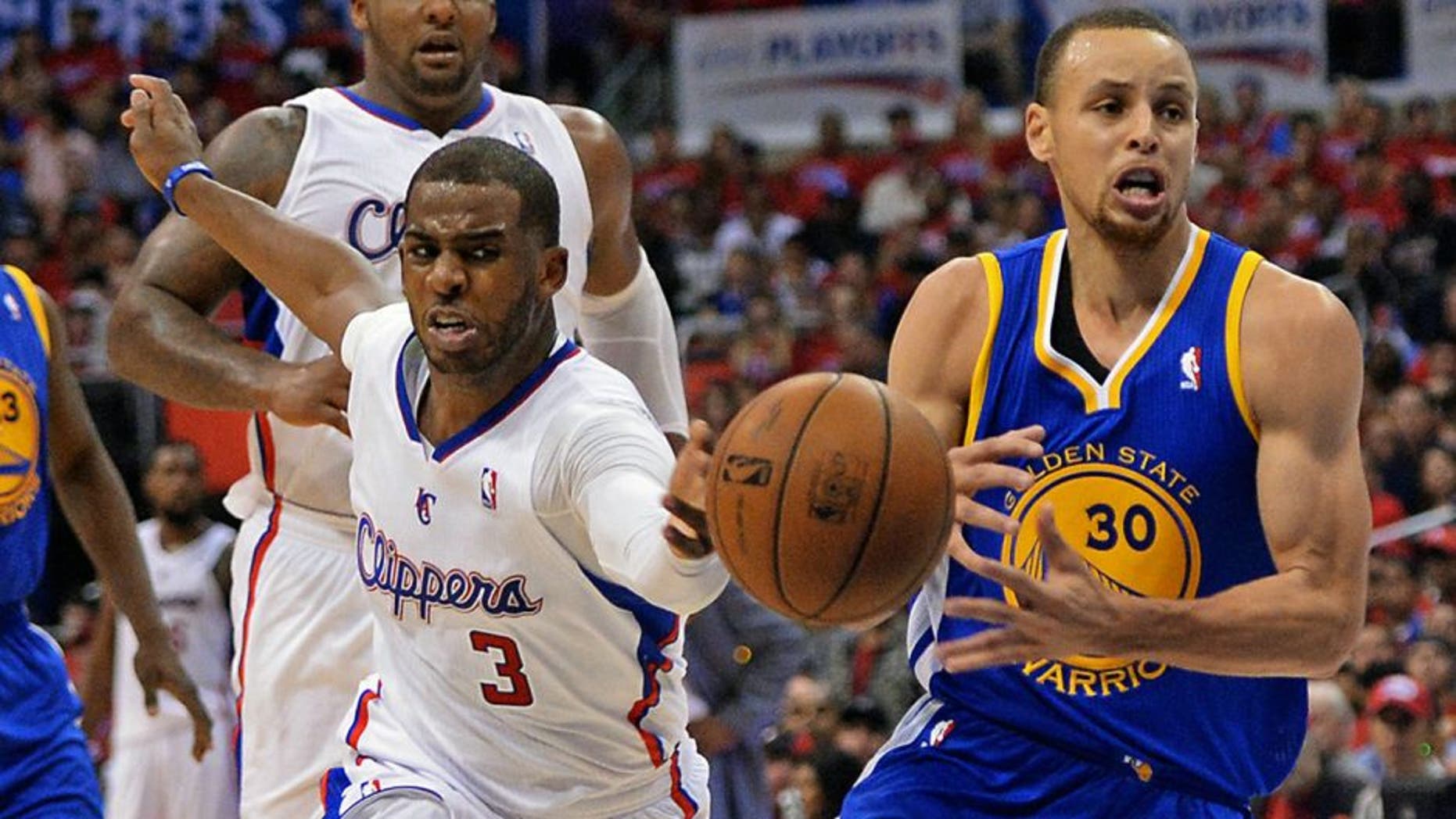 Apr 19, 2014; Los Angeles, CA, USA; Golden State Warriors guard Stephen Curry (30) drives the lane past Los Angeles Clippers guard Chris Paul (3) and center Ryan Hollins (15) in the first half in game one during the first round of the 2014 NBA Playoffs at Staples Center. Mandatory Credit: Jayne Kamin-Oncea-USA TODAY Sports