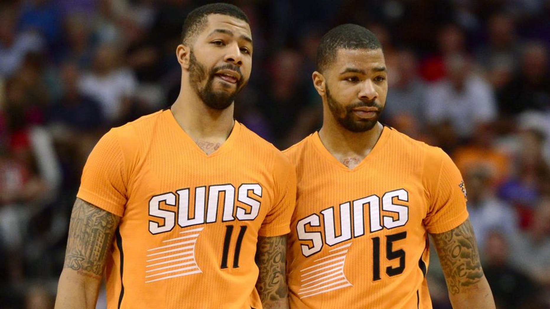 Mar 27, 2015; Phoenix, AZ, USA; Phoenix Suns forward Markieff Morris (11) and Phoenix Suns forward Marcus Morris (15) talk during a timeout against the Portland Trail Blazers at US Airways Center. The Trail Blazers won the game 87-81. Mandatory Credit: Joe Camporeale-USA TODAY Sports