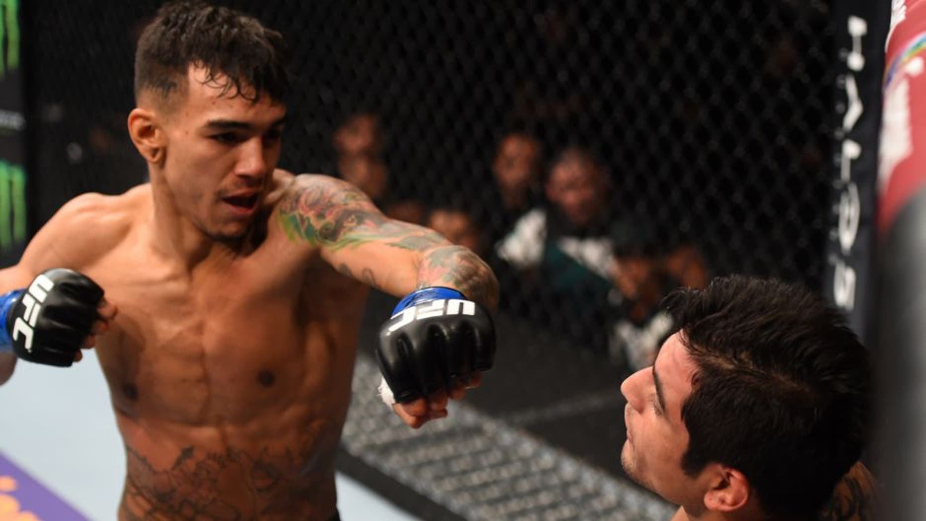 MONTERREY, MEXICO - NOVEMBER 21: (L-R) Andre Fili of the United States punches Gabriel Benitez of Mexico in their featherweight bout during the UFC Fight Night event at Arena Monterrey on November 21, 2015 in Monterrey, Mexico. (Photo by Jeff Bottari/Zuffa LLC/Zuffa LLC via Getty Images)