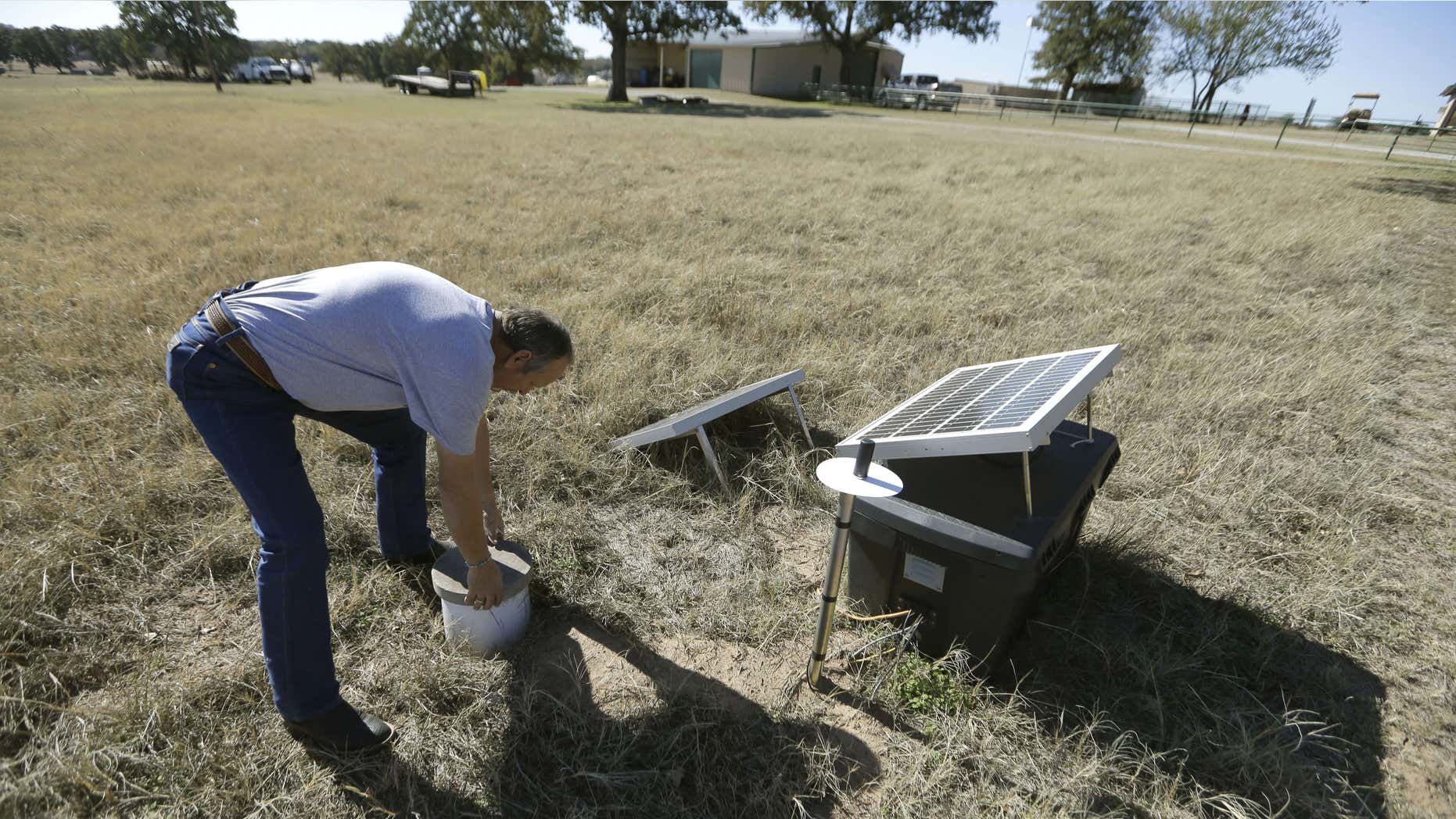 Nov. 19, 2014: In this file photo, Scott Passmore, director of public works, checks on a solar powered seismic monitor installed by Southern Methodist University that records earthquakes in the area around Reno, Texas.