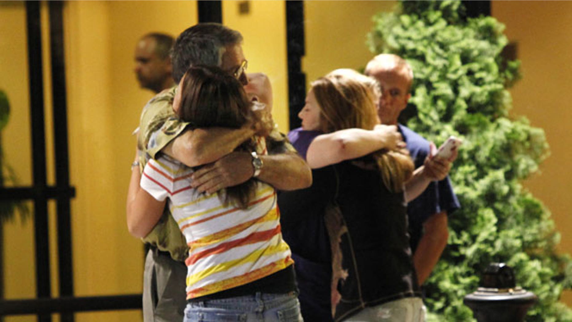 Stanley Murray, left, father of Chad Murray, who was rescued from the Deepwater Horizon oil rig that exploded in the Gulf of Mexico, and Christy Murray, background right, hug loved ones of their unidentified neighbor, a crew member reported missing, after surviving crew members arrived at a hotel in Kenner, La., Thursday, April 22, 2010.
