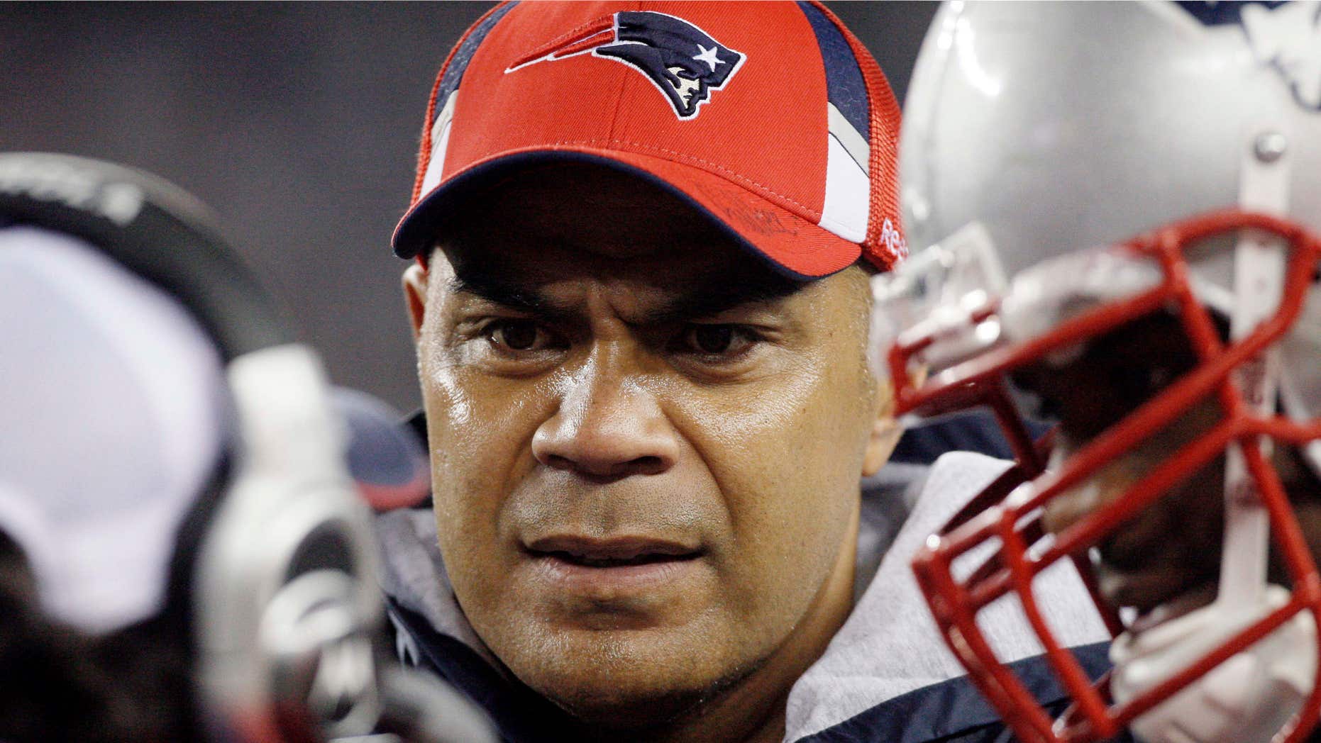 Nov. 22, 2009: New England Patriots linebacker Junior Seau, center, talks to teammates on the sidelined during an NFL football game against the New York Jets in Foxborough, Mass.