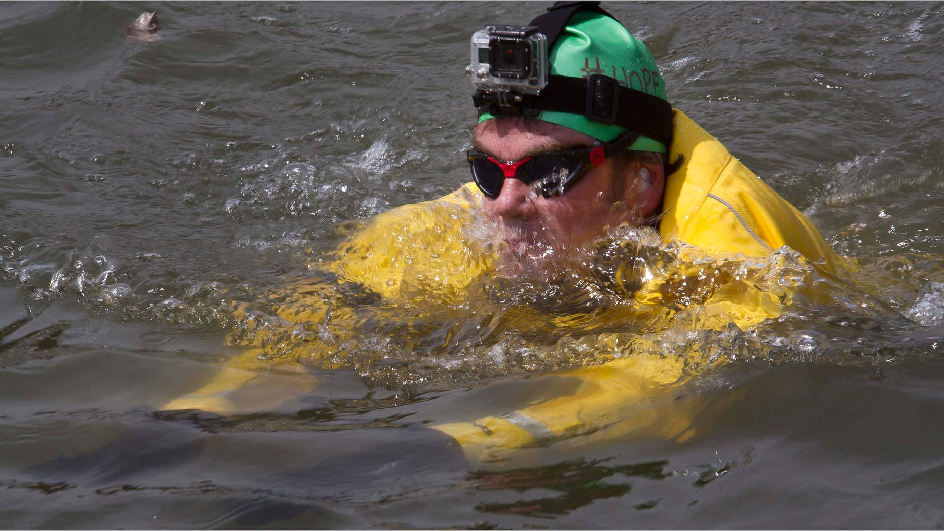 April 22, 2015: Clean-water advocate Christopher Swain swims in the Gowanus Canal in the Brooklyn borough of New York.