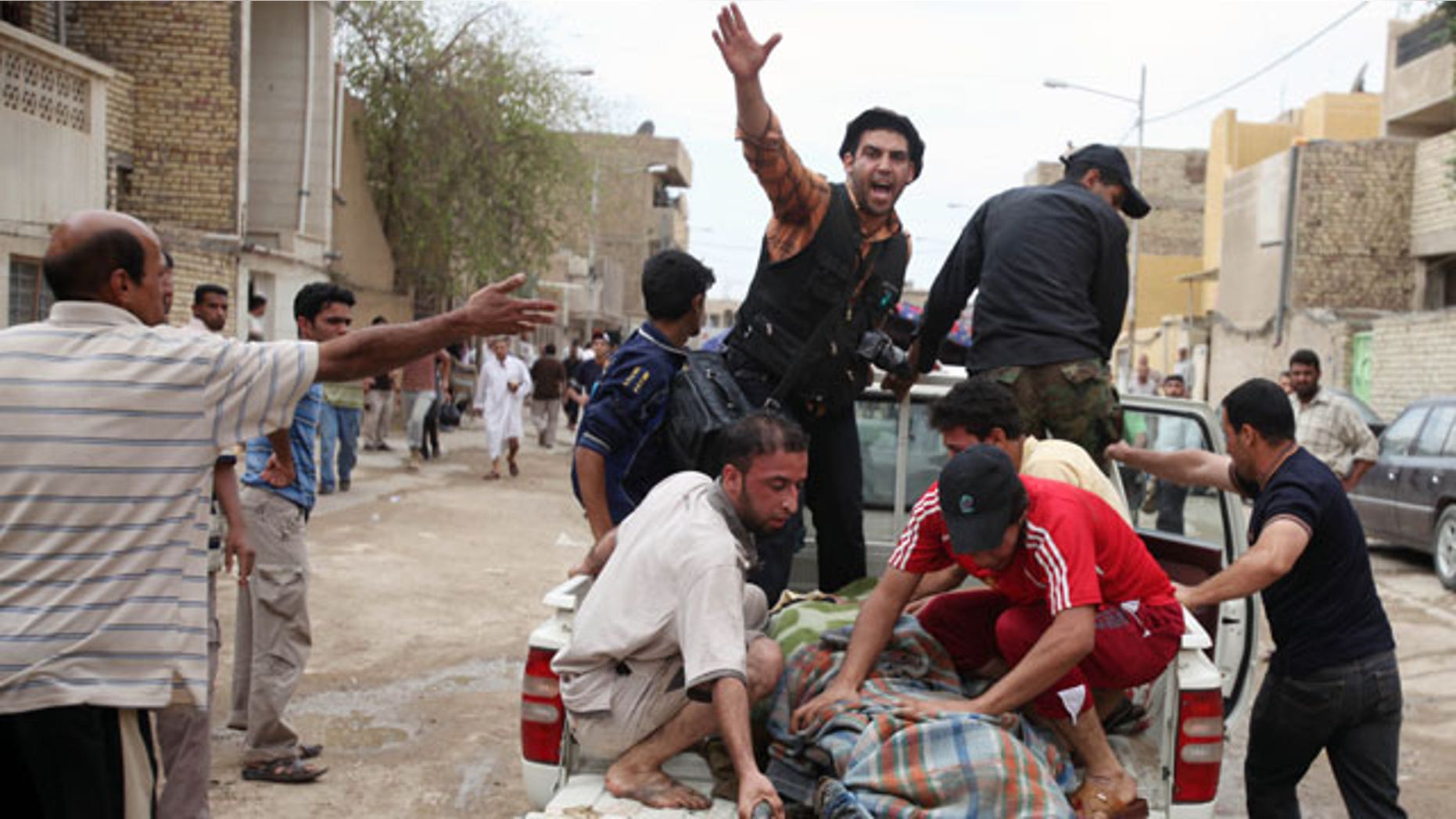 A victim is evacuated after a series of bombs exploded in the Shiite stronghold of Sadr City in Baghdad, Iraq, Friday, April 23, 2010. Iraqi officials say several people were killed when a series of bombs targeted the Sadrist offices. The bombings appeared to be targeting worshippers on their way to and from Friday afternoon prayers.