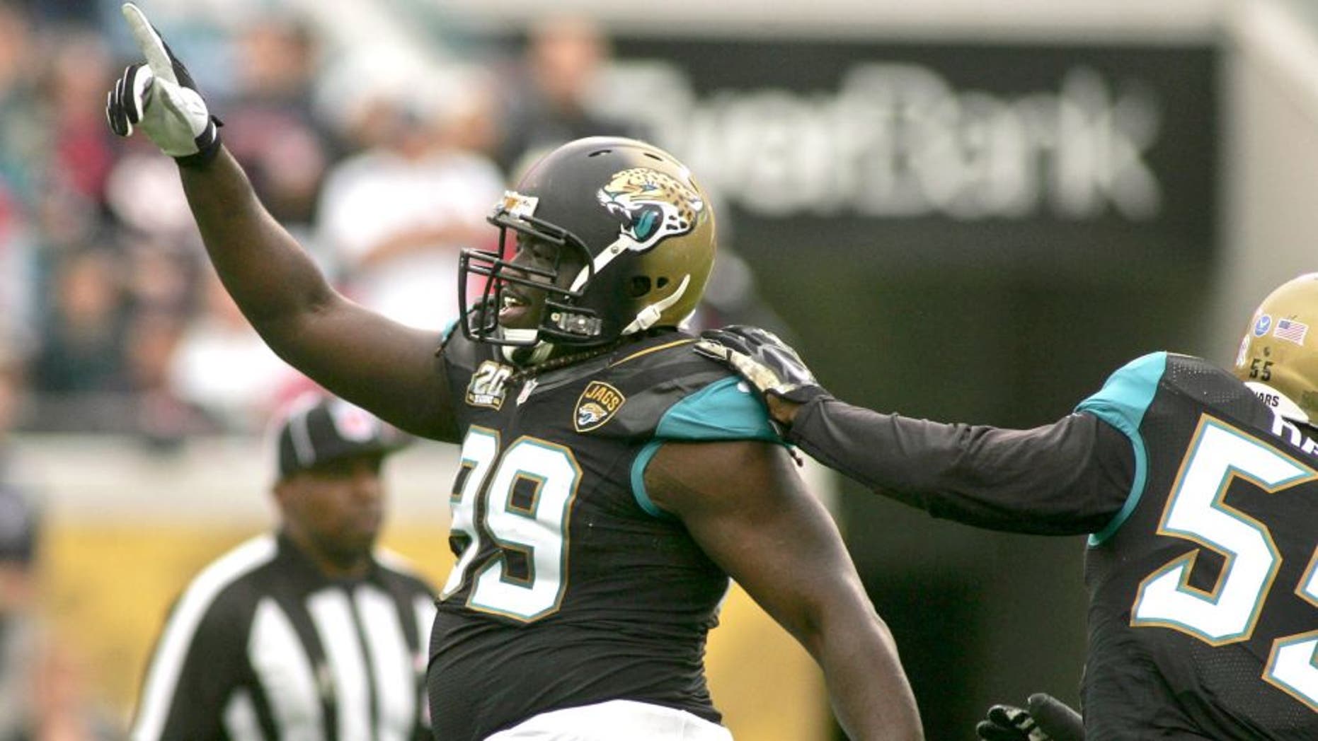 Dec 7, 2014; Jacksonville, FL, USA; Jacksonville Jaguars defensive tackle Sen'Derrick Marks (99) celebrates after a sack in the first quarter of their game against the Houston Texans at EverBank Field. Mandatory Credit: Phil Sears-USA TODAY Sports