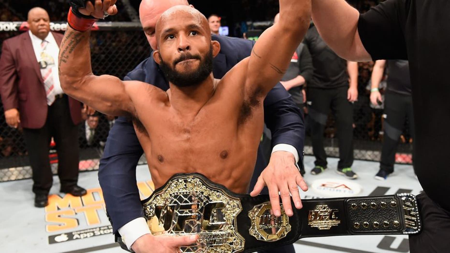 LAS VEGAS, NV - APRIL 23: Demetrious Johnson celebrates his TKO victory over Henry Cejudo in their flyweight championship bout during the UFC 197 event inside MGM Grand Garden Arena on April 23, 2016 in Las Vegas, Nevada. (Photo by Josh Hedges/Zuffa LLC/Zuffa LLC via Getty Images)