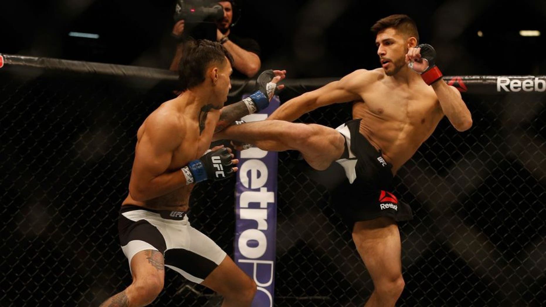 LAS VEGAS, NV - APRIL 23: (R-L) Yair Rodriguez of Mexico kicks Andre Fili in their featherweight bout during the UFC 197 event inside MGM Grand Garden Arena on April 23, 2016 in Las Vegas, Nevada. (Photo by Christian Petersen/Zuffa LLC/Zuffa LLC via Getty Images)