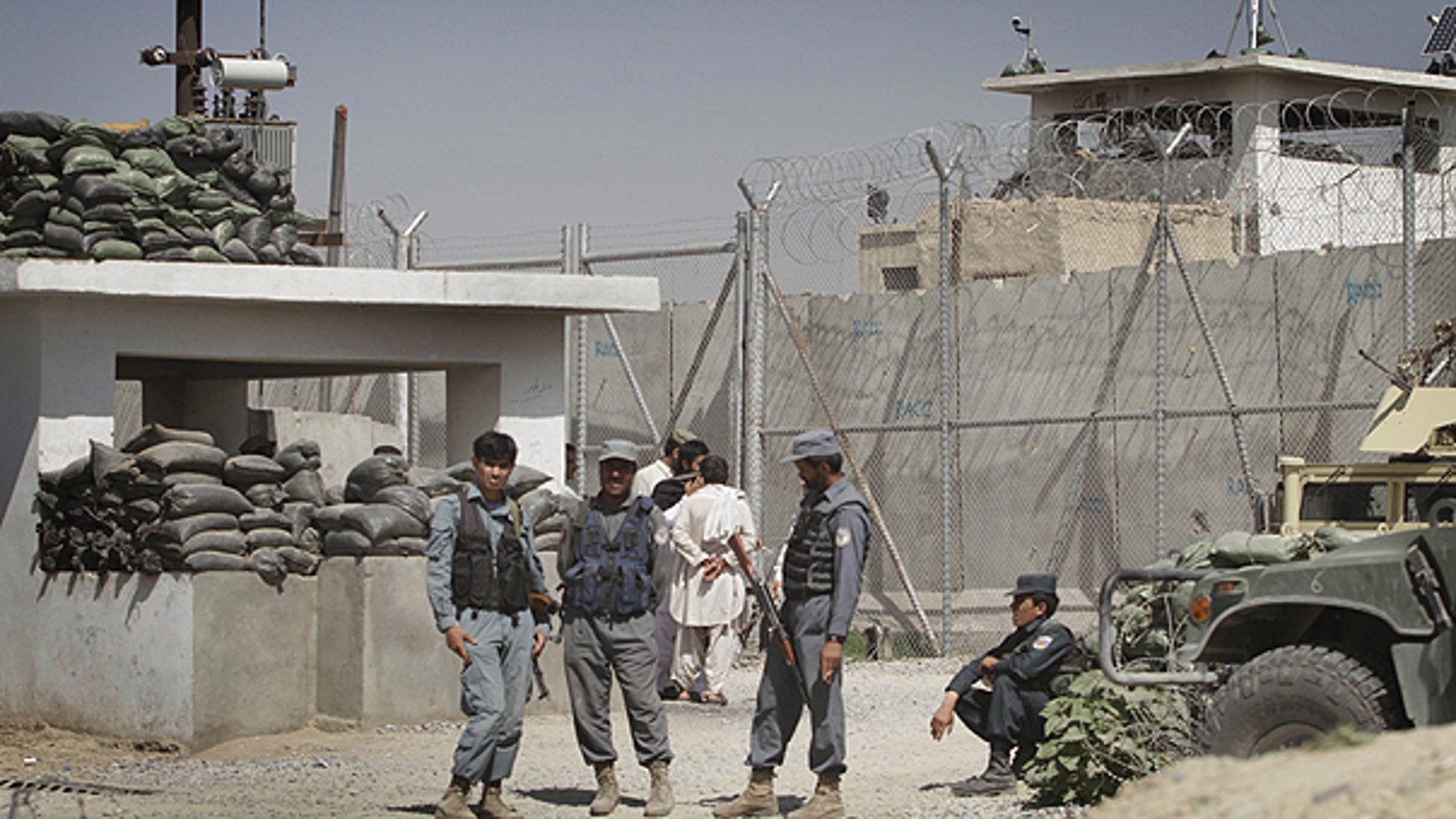 April 25: Afghan policemen stand in front of gate of the main prison in Kandahar, south of Kabul, Afghanistan.