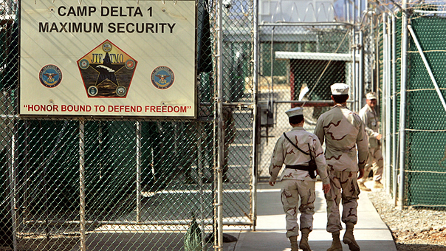 In this file photo from June 27, 2006, reviewed by a U.S. Department of Defense official, U.S. military guards walk within Camp Delta military-run prison, at the Guantanamo Bay U.S. Naval Base, Cuba.